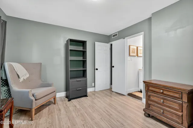 a view of room with furniture and wooden floor