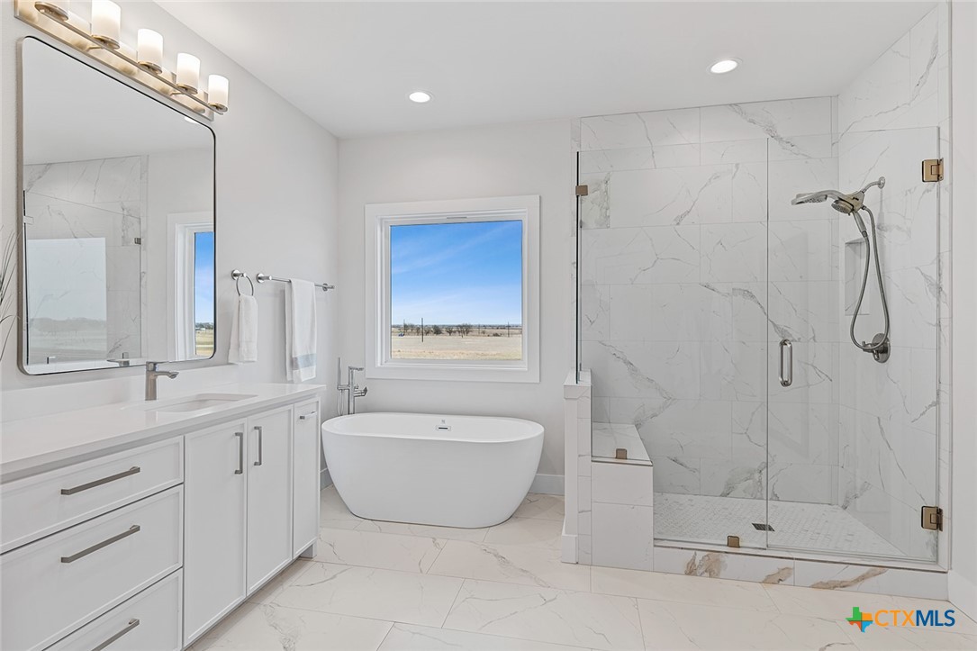 477 Willow Moon Ranch Road Crawford, TX 76638 - Photo 22 of 40 a bath room with a bath tub and a shower