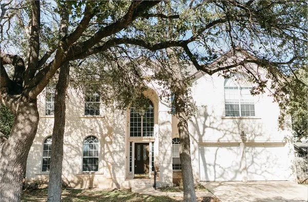 a view of a house with a tree