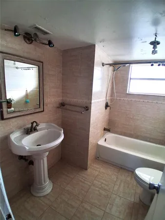 a bathroom with a toilet and a bathtub