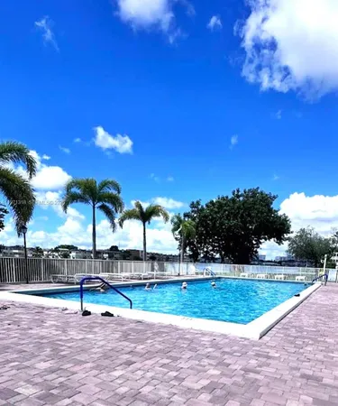 a view of a swimming pool with a yard
