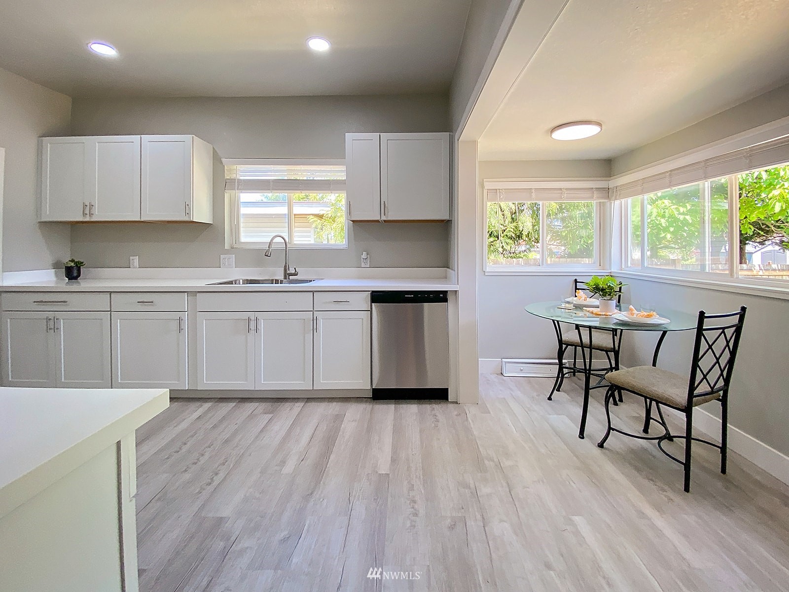 1005 9th Street Southwest Puyallup, WA 98371 - Photo 11 of 40 a kitchen with a table chairs sink and cabinets