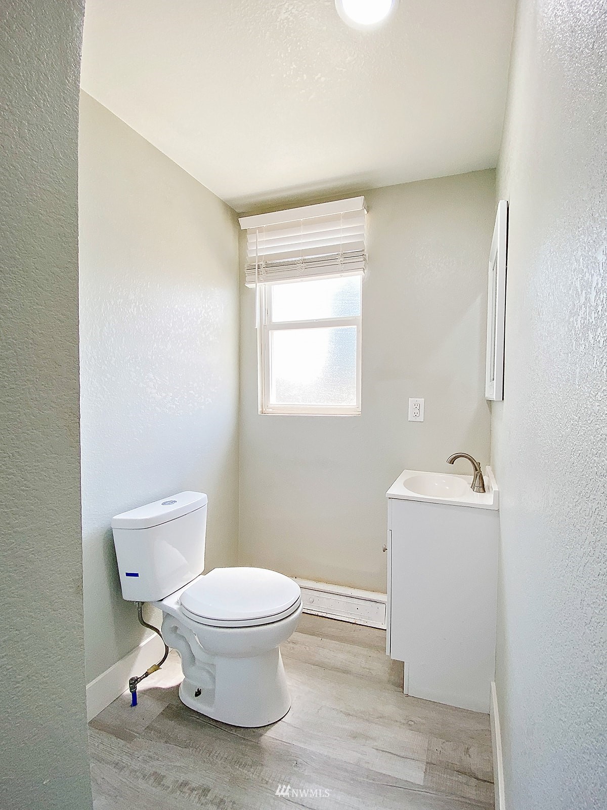 1005 9th Street Southwest Puyallup, WA 98371 - Photo 22 of 40 a white toilet sitting next to a bathroom sink
