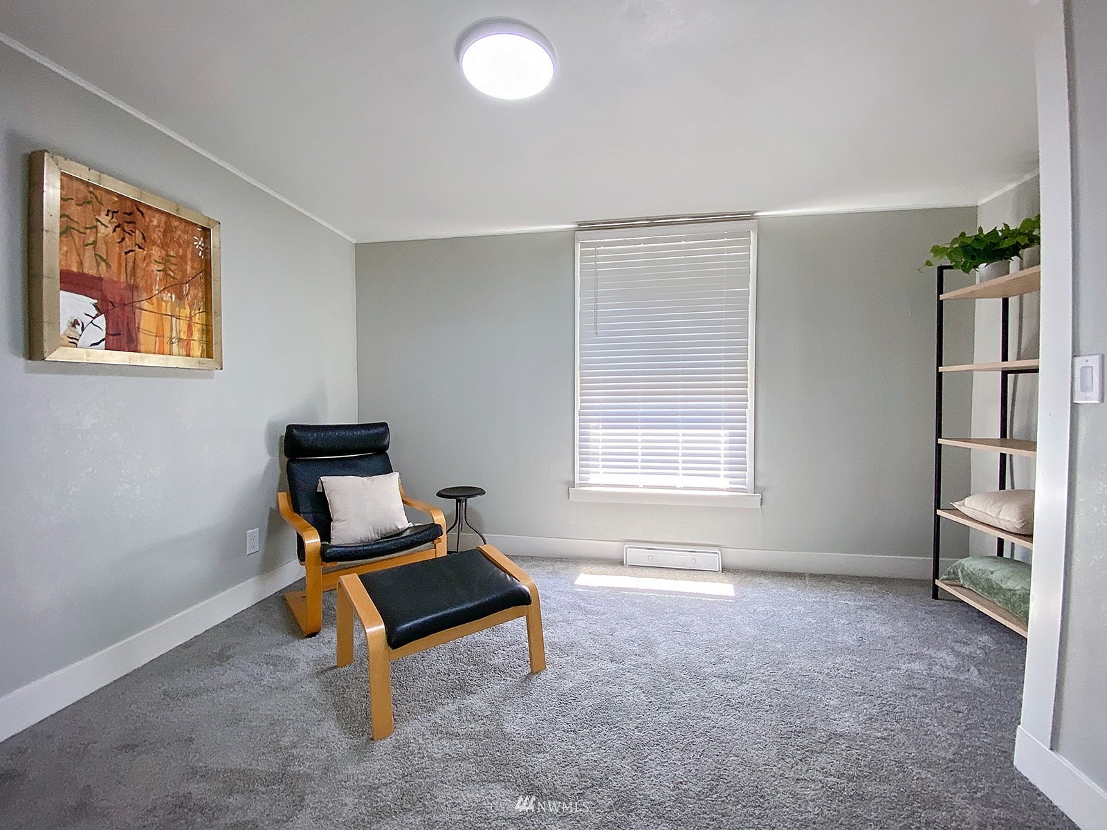 1005 9th Street Southwest Puyallup, WA 98371 - Photo 34 of 40 a living room with a bed furniture and a window