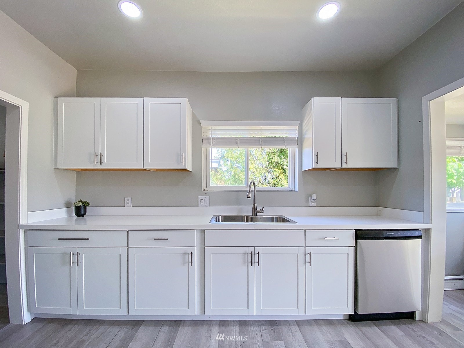 1005 9th Street Southwest Puyallup, WA 98371 - Photo 10 of 40 a kitchen with white cabinets and white appliances