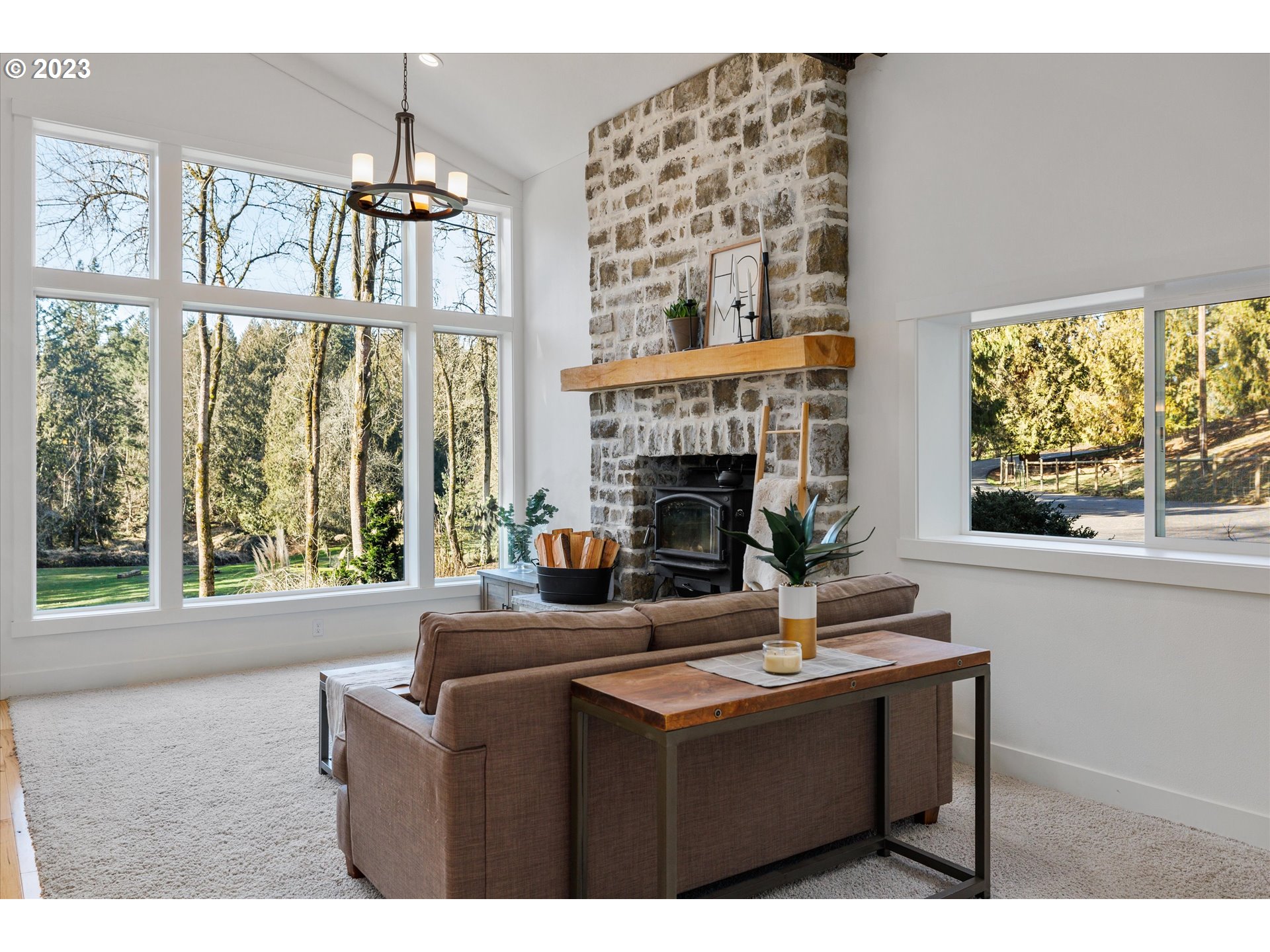 22543 South Central Point Road Oregon City, OR 97045 - Photo 6 of 32 a living room with furniture a window and a fireplace