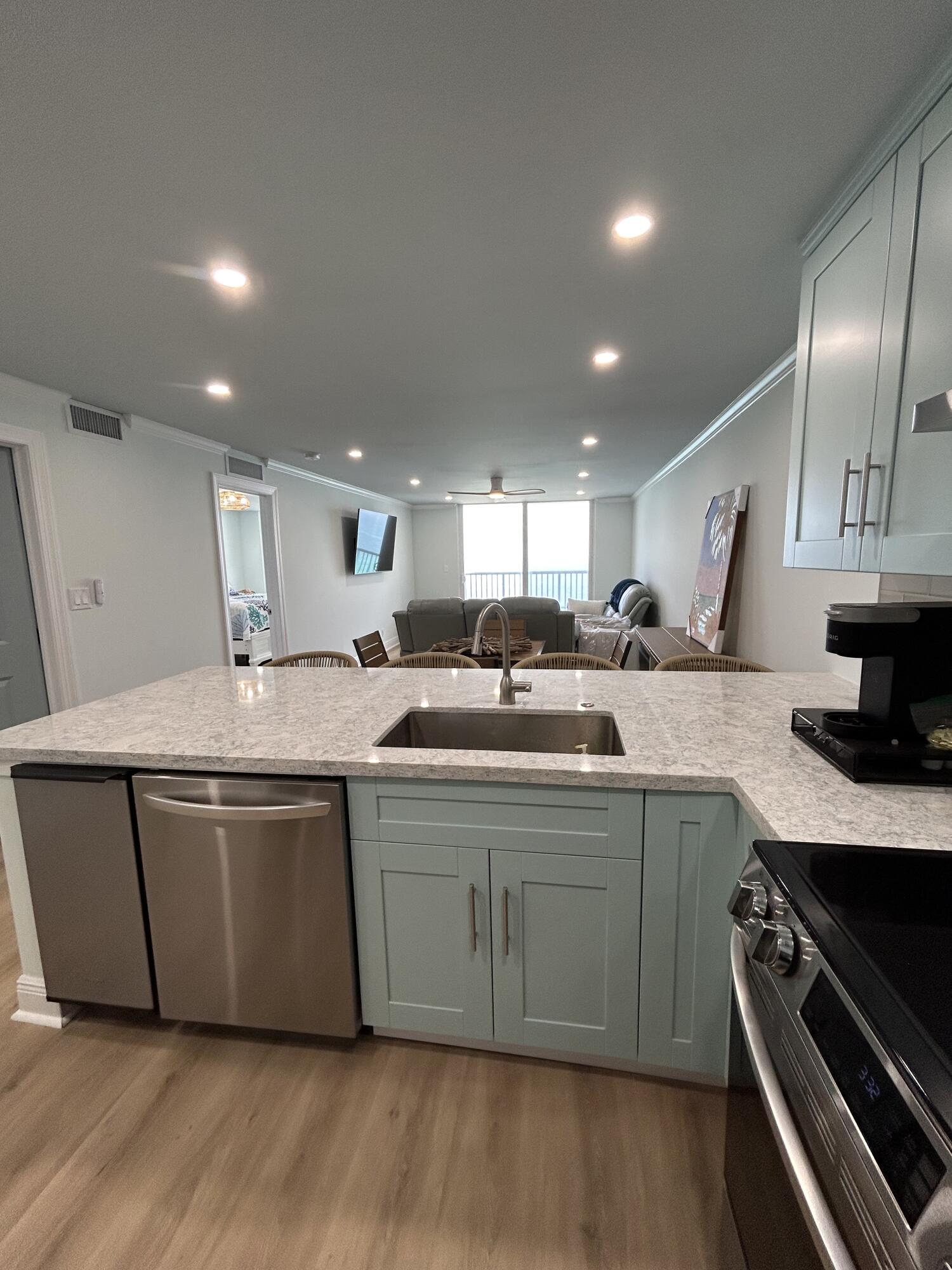400 North Surf Road, Unit 1105 Hollywood, FL 33019 - Photo 2 of 15 a large kitchen with stainless steel appliances granite countertop a stove and a sink