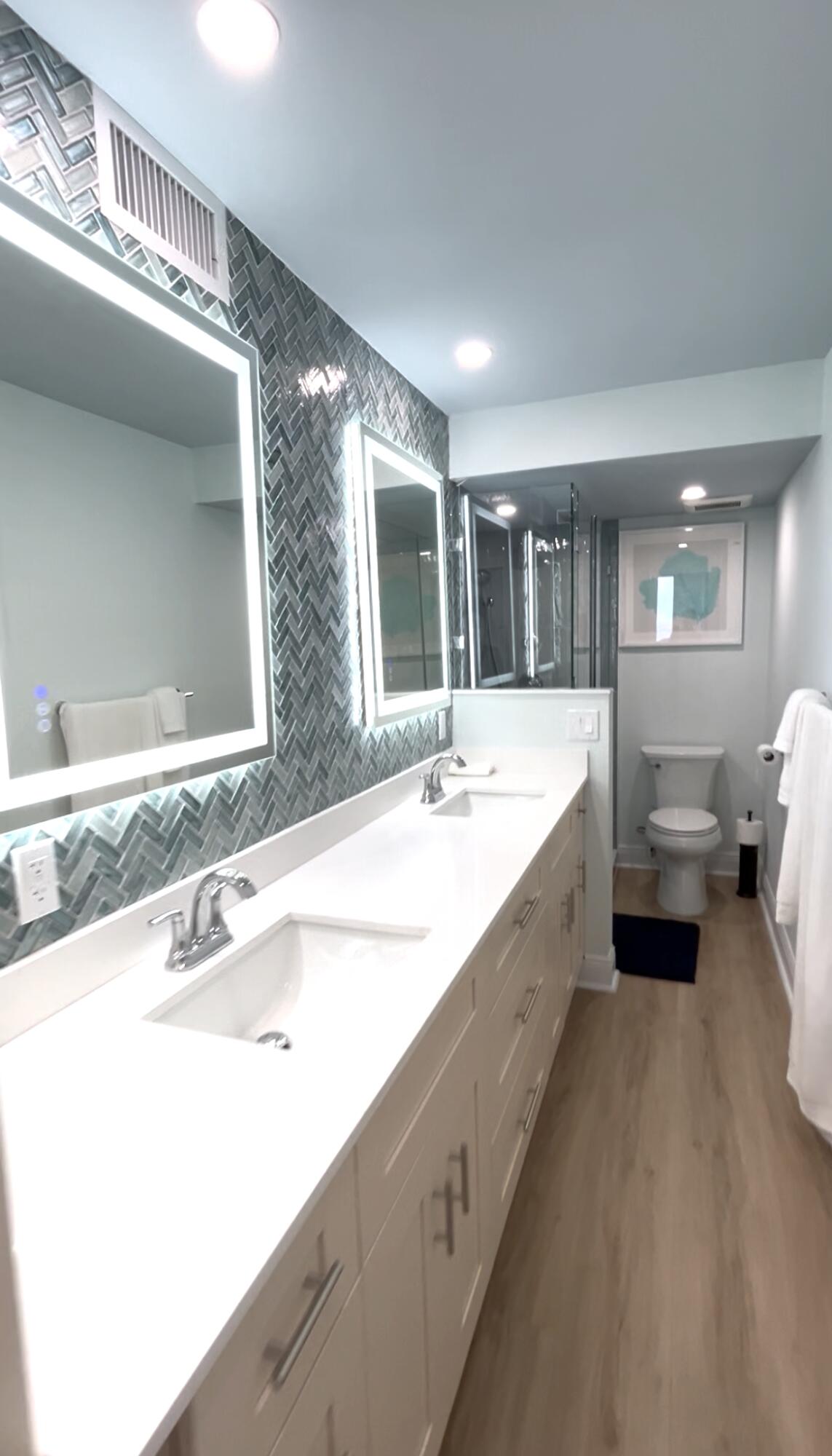400 North Surf Road, Unit 1105 Hollywood, FL 33019 - Photo 9 of 15 a spacious bathroom with a double vanity sink and a large mirror