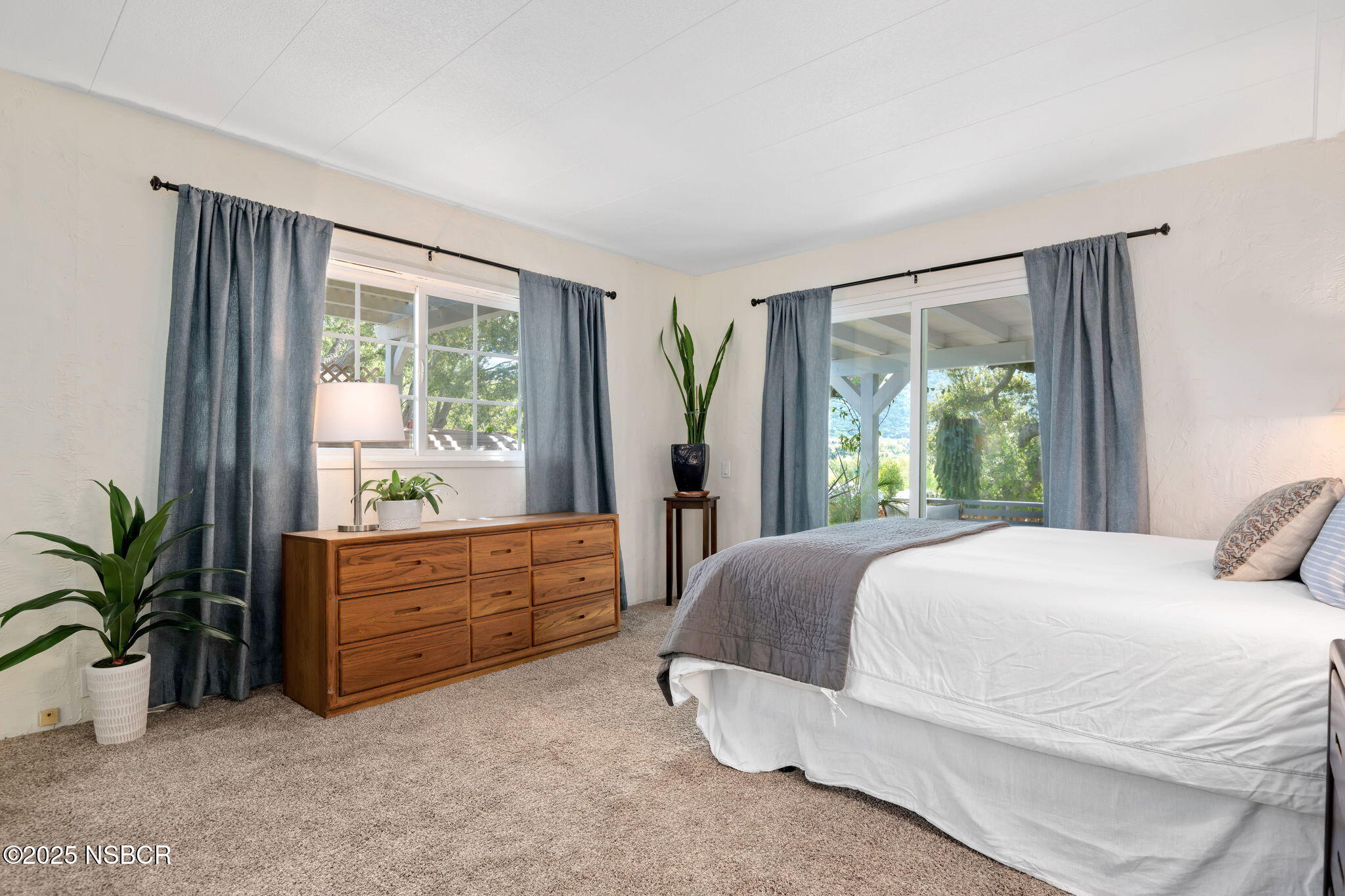 9 Paseo Del Rio Solvang, CA 93463 - Photo 14 of 32 a bedroom with a bed and large windows