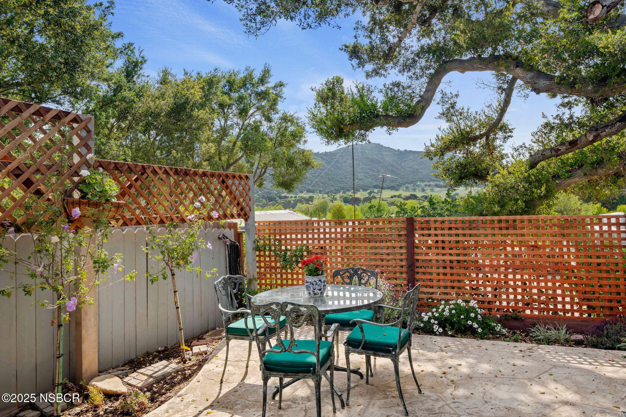 9 Paseo Del Rio Solvang, CA 93463 - Photo 24 of 32 a balcony with table and chairs and potted plants