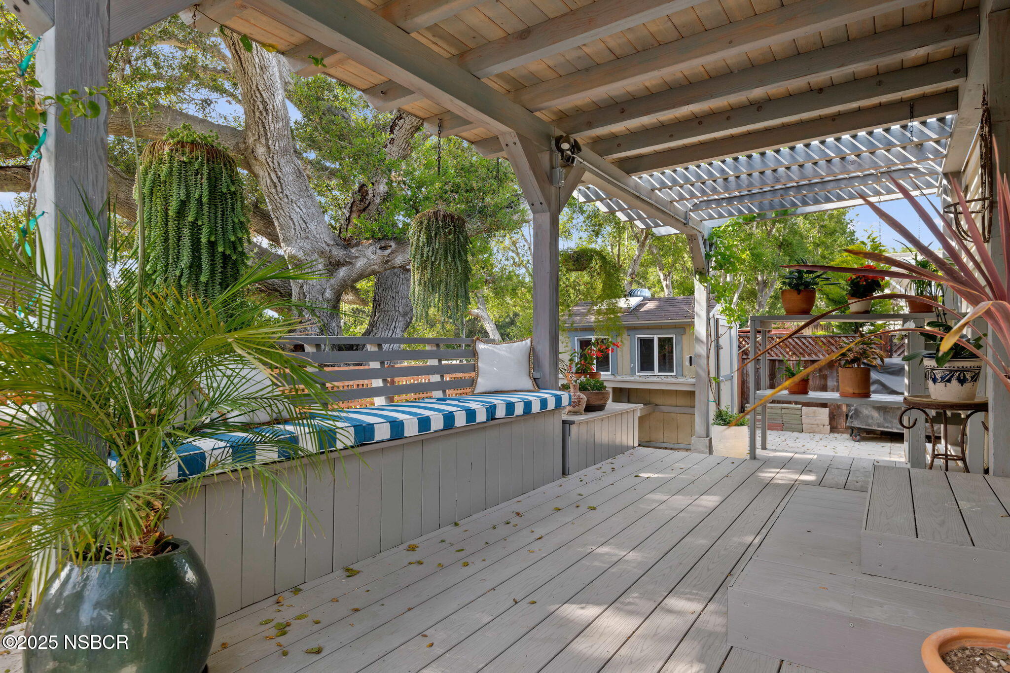 9 Paseo Del Rio Solvang, CA 93463 - Photo 25 of 32 a view of a patio with table and chairs with wooden floor and fence