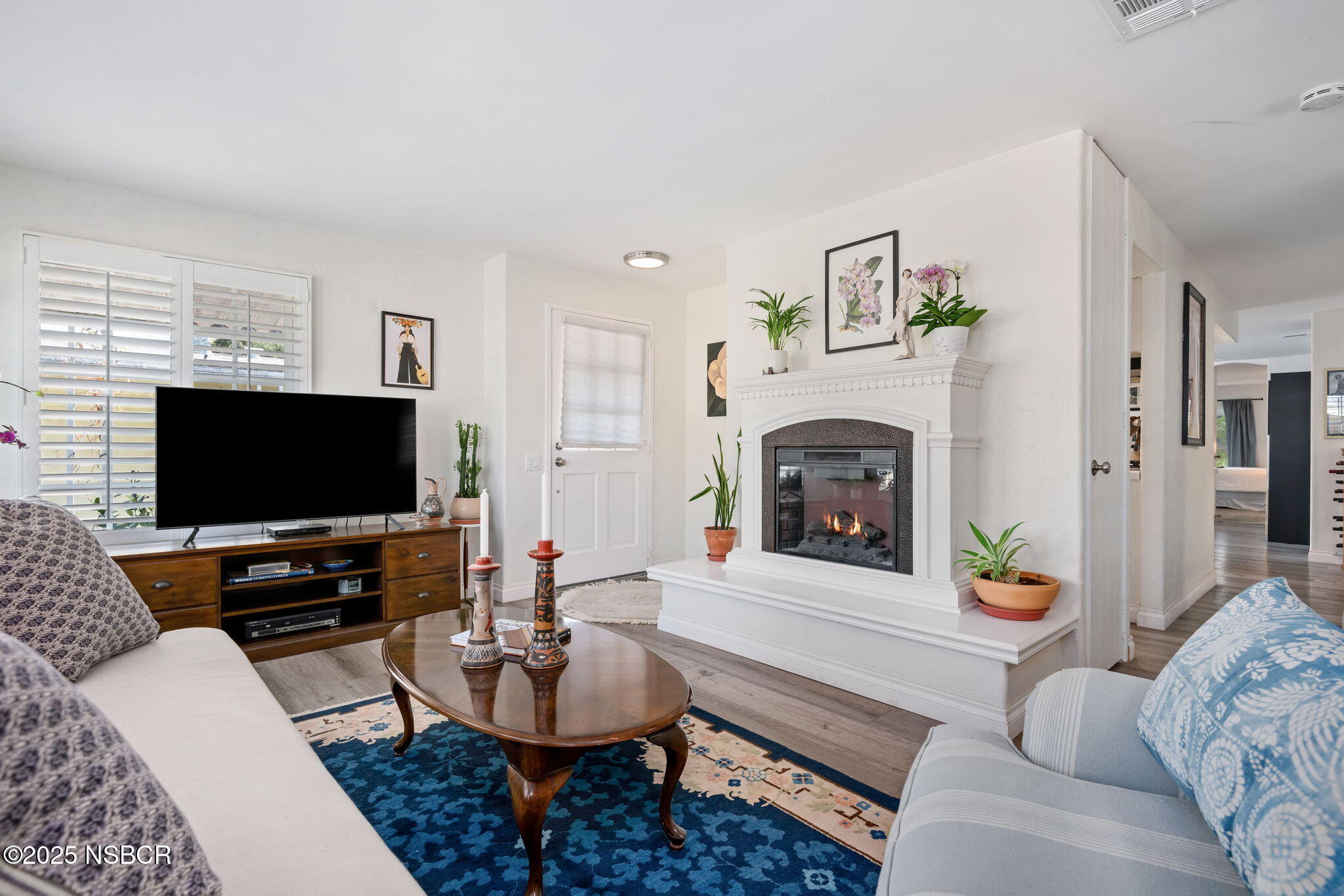 9 Paseo Del Rio Solvang, CA 93463 - Photo 10 of 32 a living room with furniture a fireplace and a flat screen tv