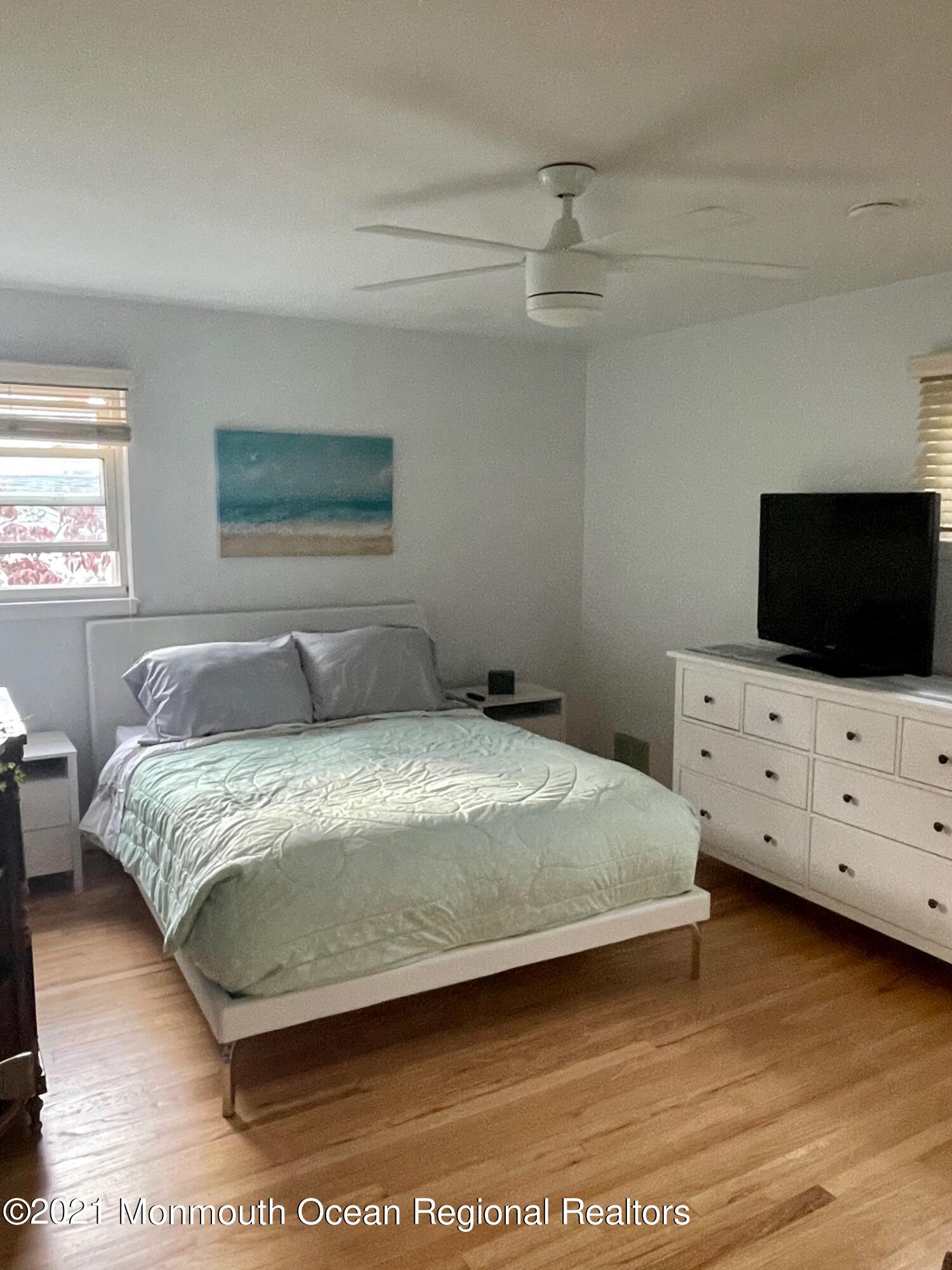 137 Crestview Drive Middletown, NJ 07748 - Photo 11 of 18 a bedroom with a bed and flat screen tv