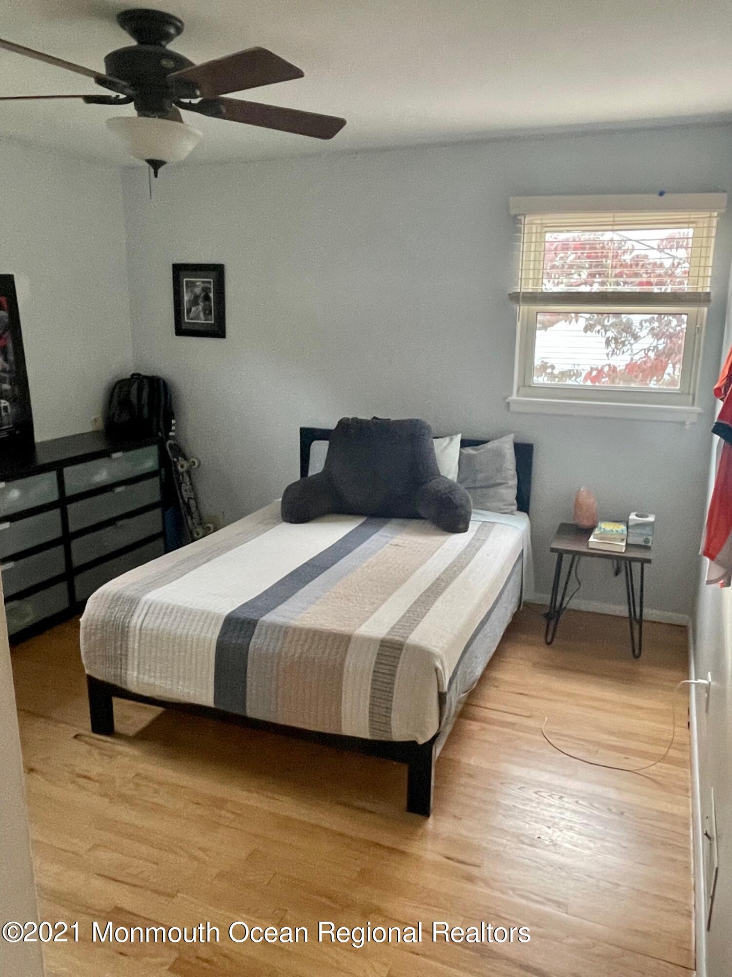 137 Crestview Drive Middletown, NJ 07748 - Photo 13 of 18 a bedroom with a bed a dresser next to a window