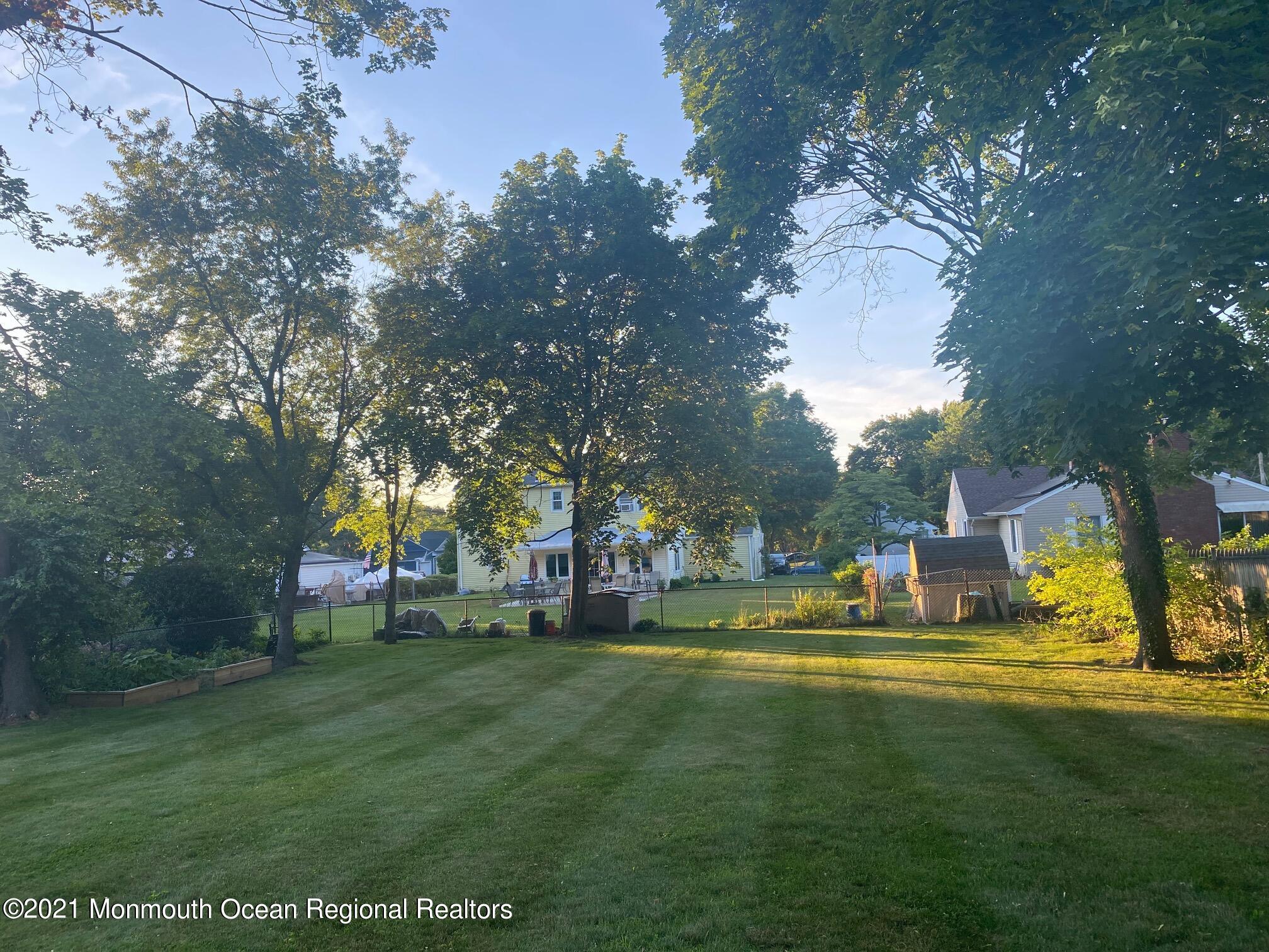 137 Crestview Drive Middletown, NJ 07748 - Photo 16 of 18 a view of a fountain in front of a house with a big yard