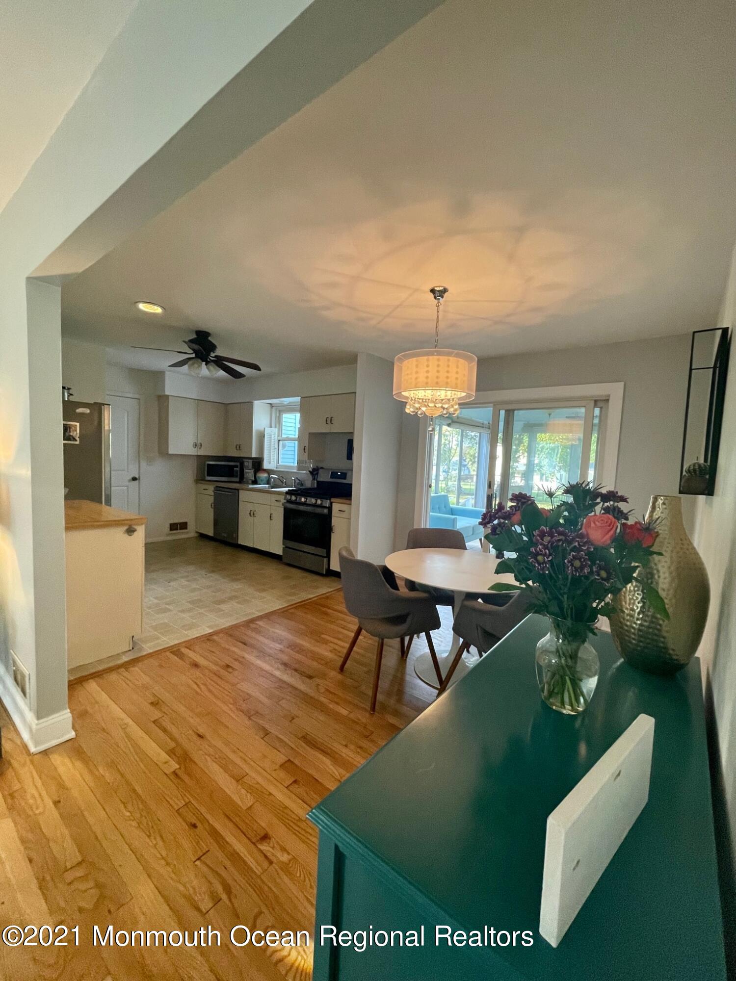 137 Crestview Drive Middletown, NJ 07748 - Photo 5 of 18 a living room with furniture and a dining table with kitchen view