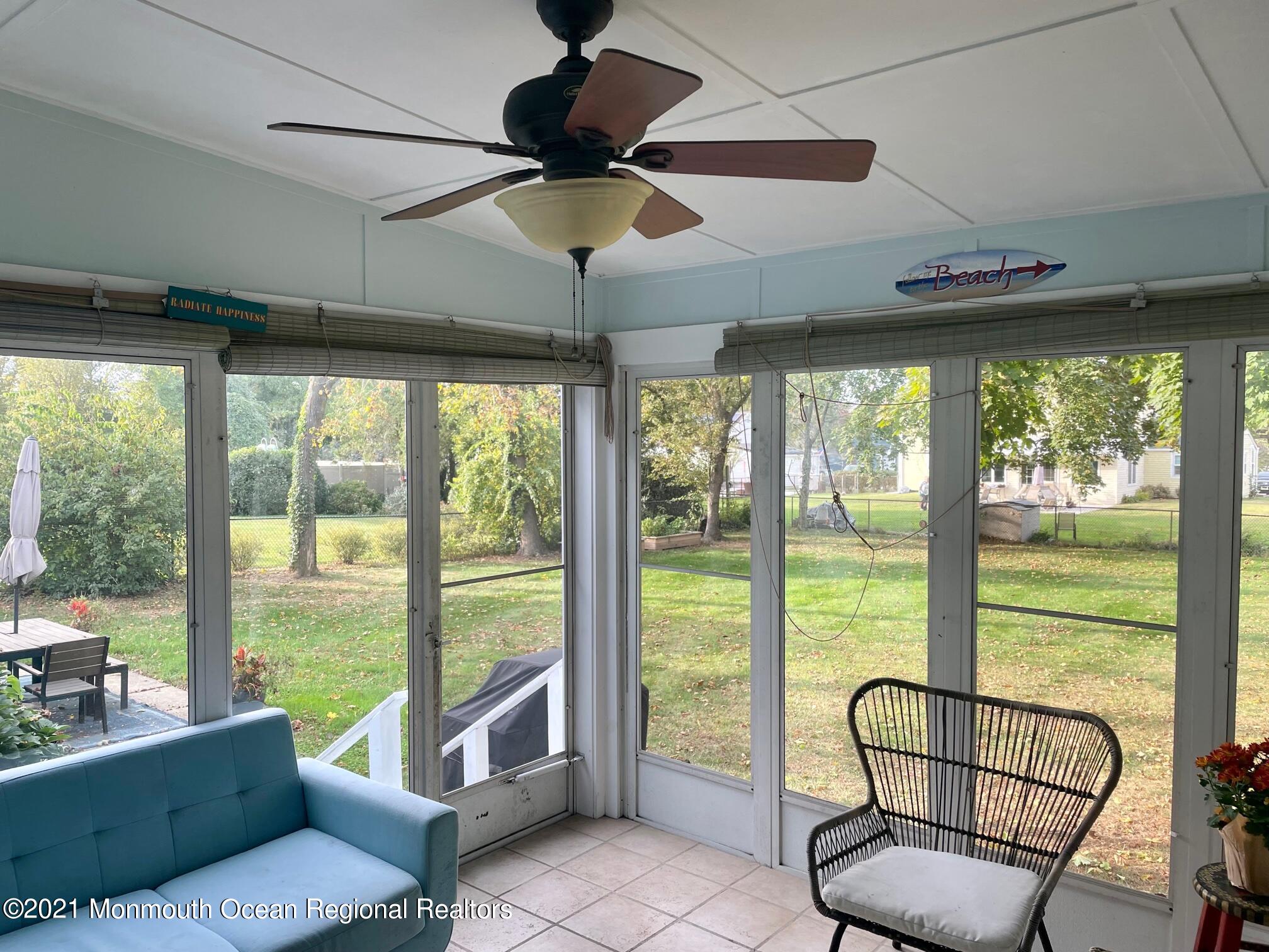 137 Crestview Drive Middletown, NJ 07748 - Photo 7 of 18 a living room with furniture and a floor to ceiling window