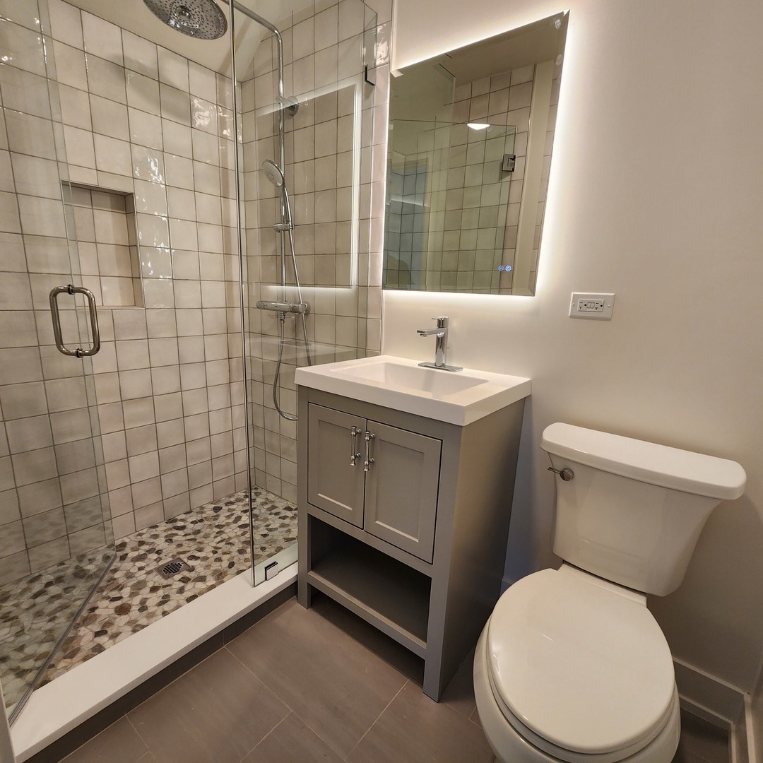 1975 Sunset Ridge Road Northfield, IL 60093 - Photo 18 of 21 a bathroom with a sink toilet and shower