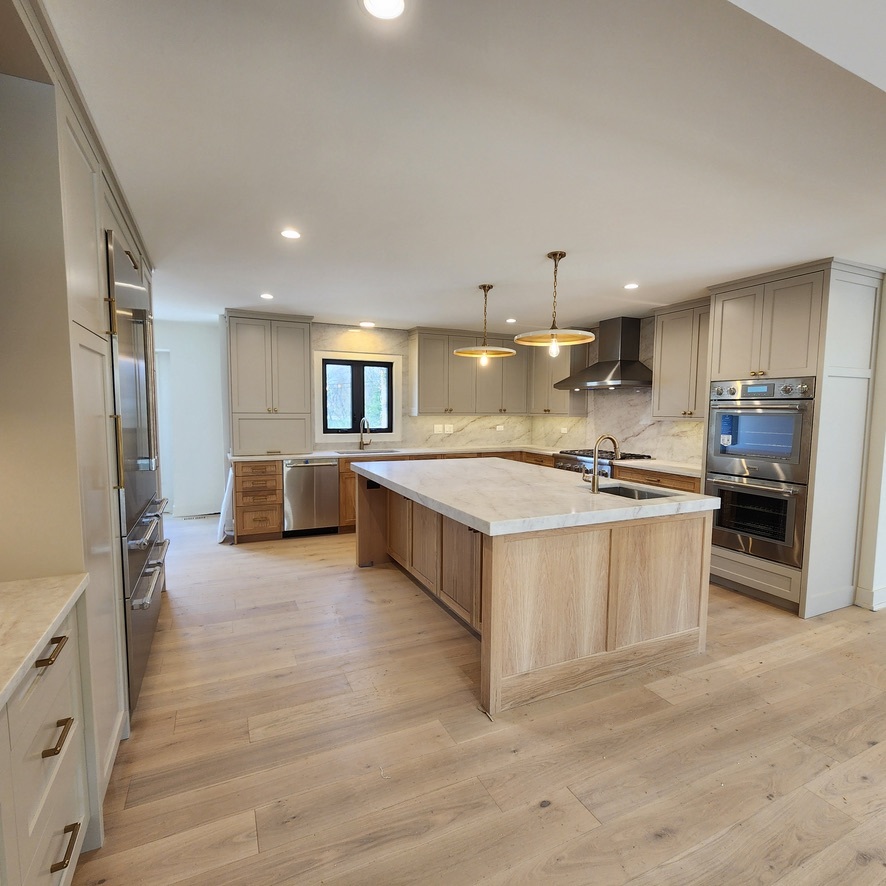 1975 Sunset Ridge Road Northfield, IL 60093 - Photo 9 of 21 a large kitchen with stainless steel appliances a large counter top a stove and a refrigerator