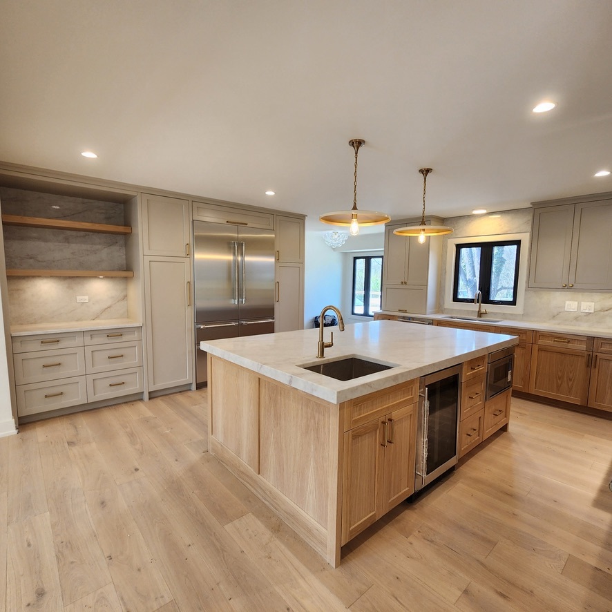 1975 Sunset Ridge Road Northfield, IL 60093 - Photo 10 of 21 a large kitchen with stainless steel appliances a large counter top a sink a stove and a refrigerator