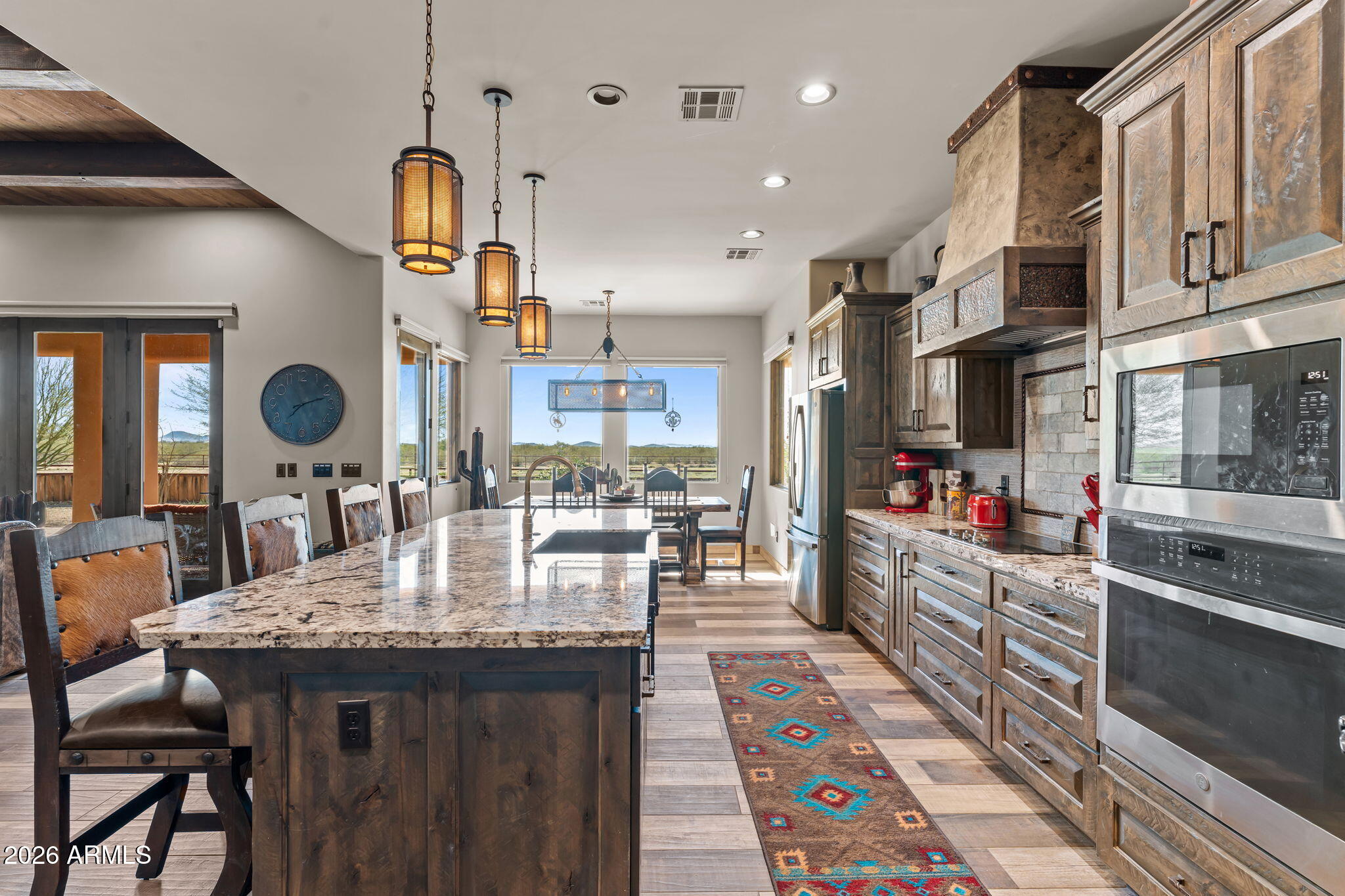 46629 West Luray Road Wickenburg, AZ 85390 - Photo 26 of 64 a kitchen with stainless steel appliances granite countertop a kitchen island a stove and a cabinets