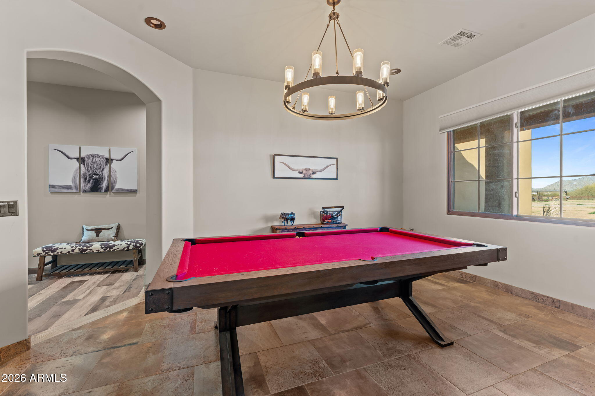 46629 West Luray Road Wickenburg, AZ 85390 - Photo 29 of 64 a living room with a table and chandelier