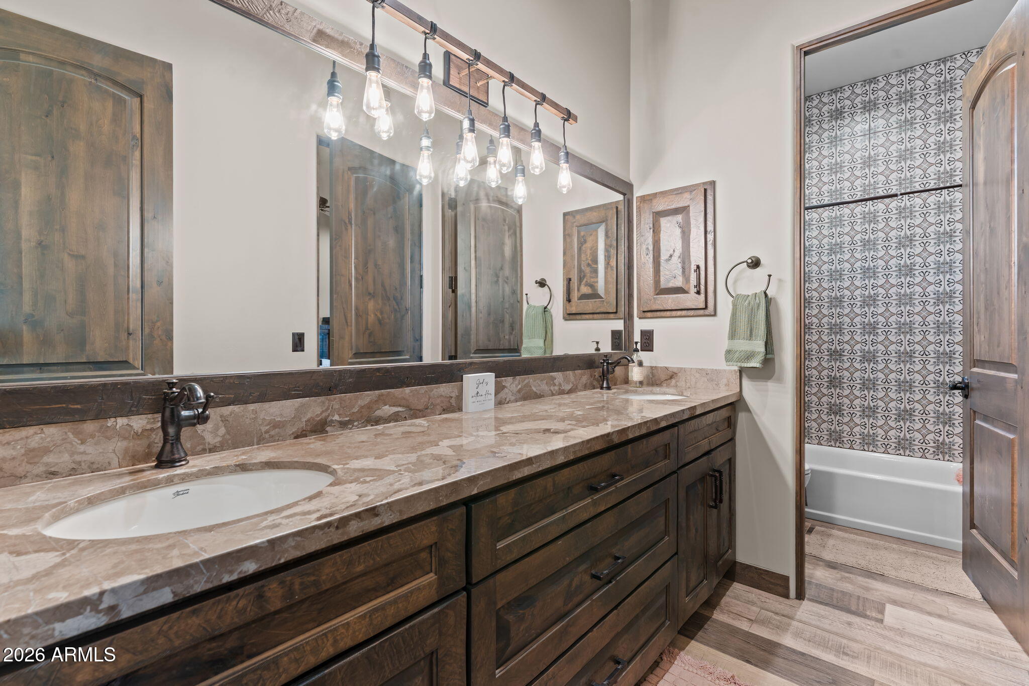 46629 West Luray Road Wickenburg, AZ 85390 - Photo 34 of 64 a bathroom with a granite countertop sink a large mirror and a shower