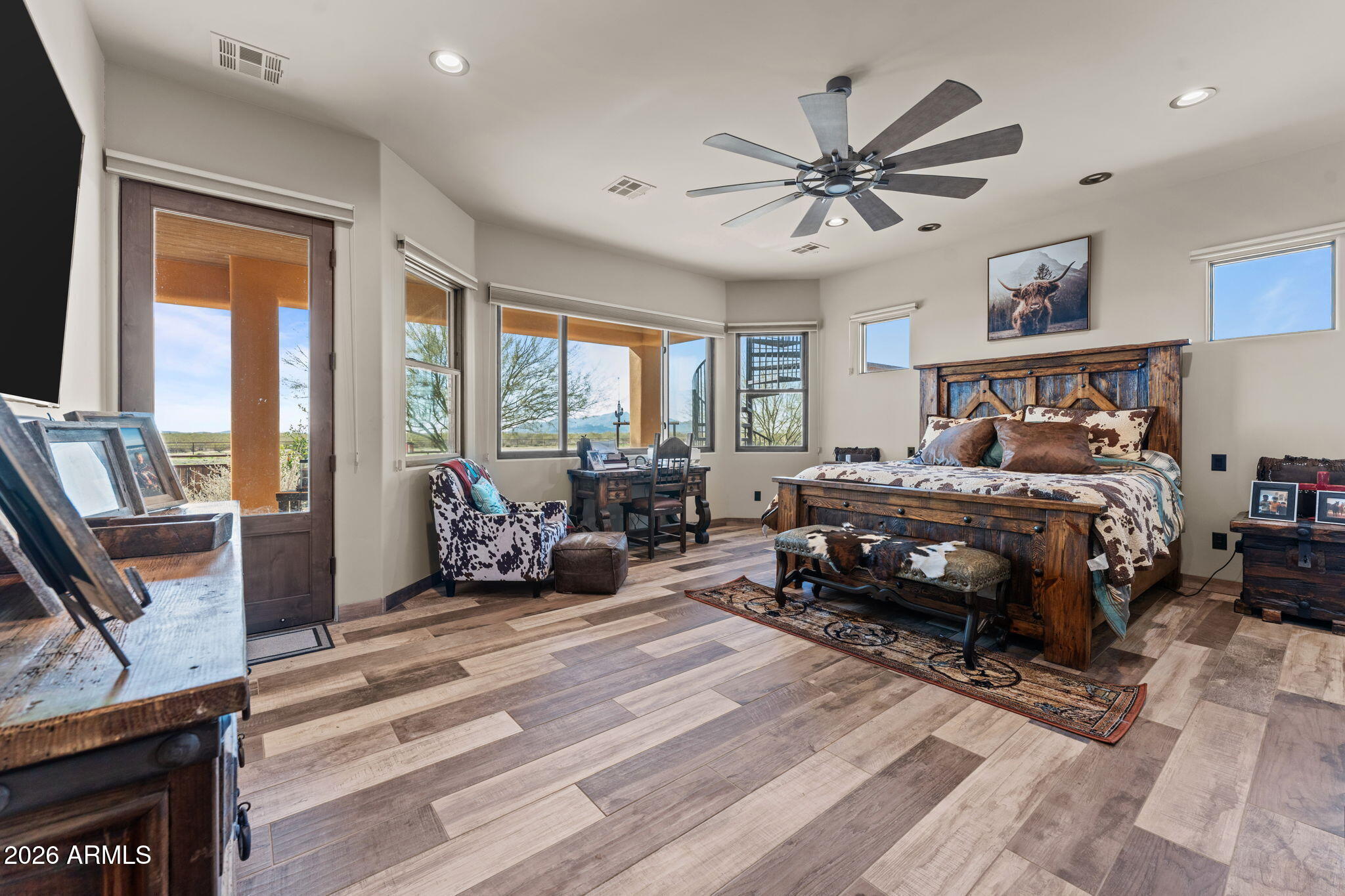 46629 West Luray Road Wickenburg, AZ 85390 - Photo 38 of 64 a bedroom with a bed a chandelier and a large window