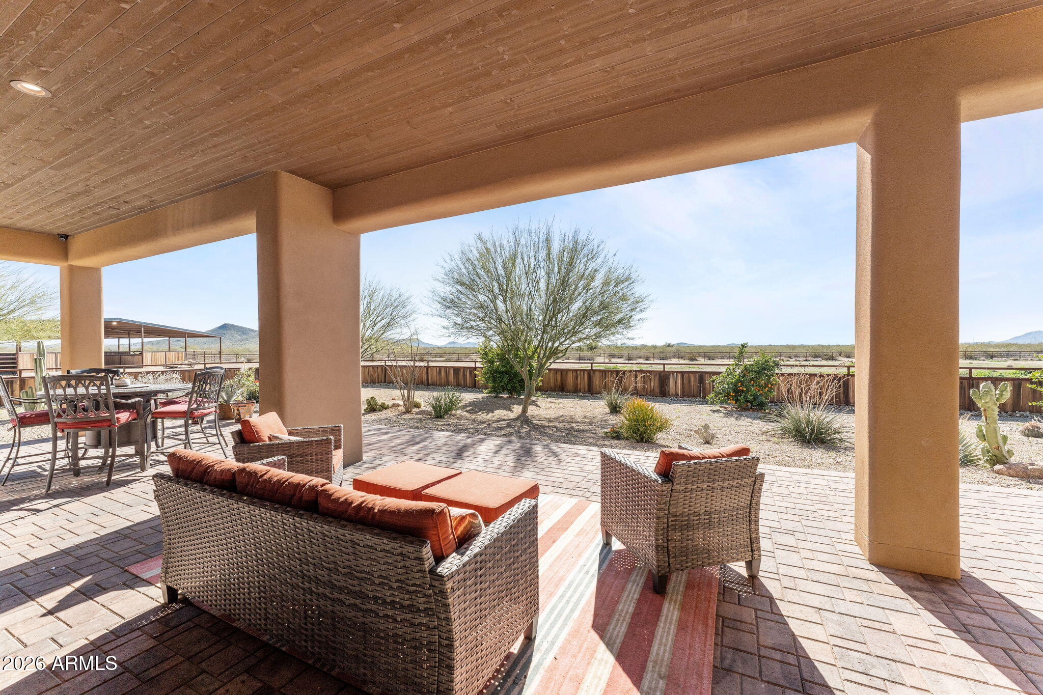 46629 West Luray Road Wickenburg, AZ 85390 - Photo 44 of 64 a living room with patio furniture and a floor to ceiling window next to a yard