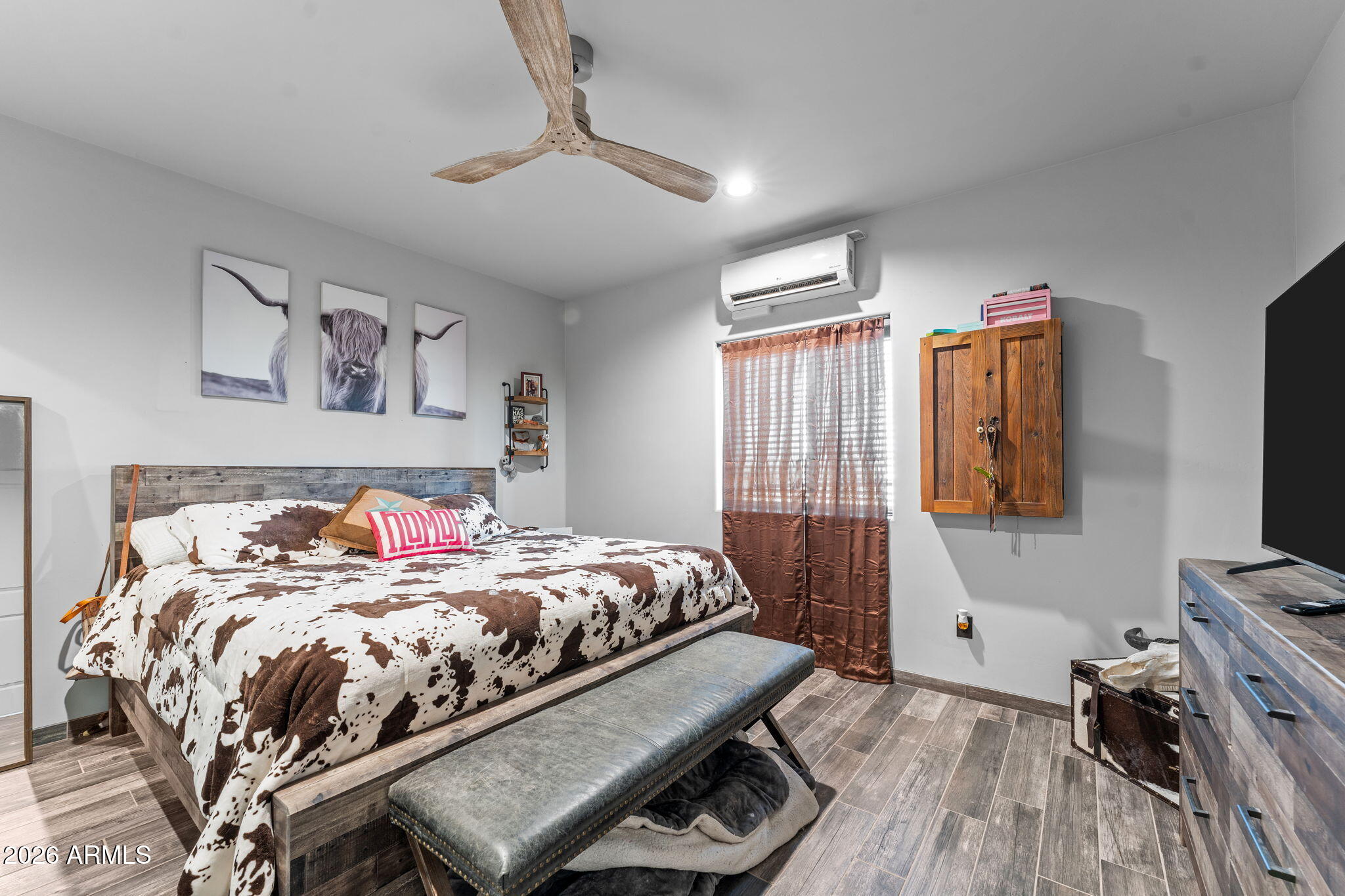 46629 West Luray Road Wickenburg, AZ 85390 - Photo 63 of 64 a bedroom with a bed and a flat tv screen on a dresser