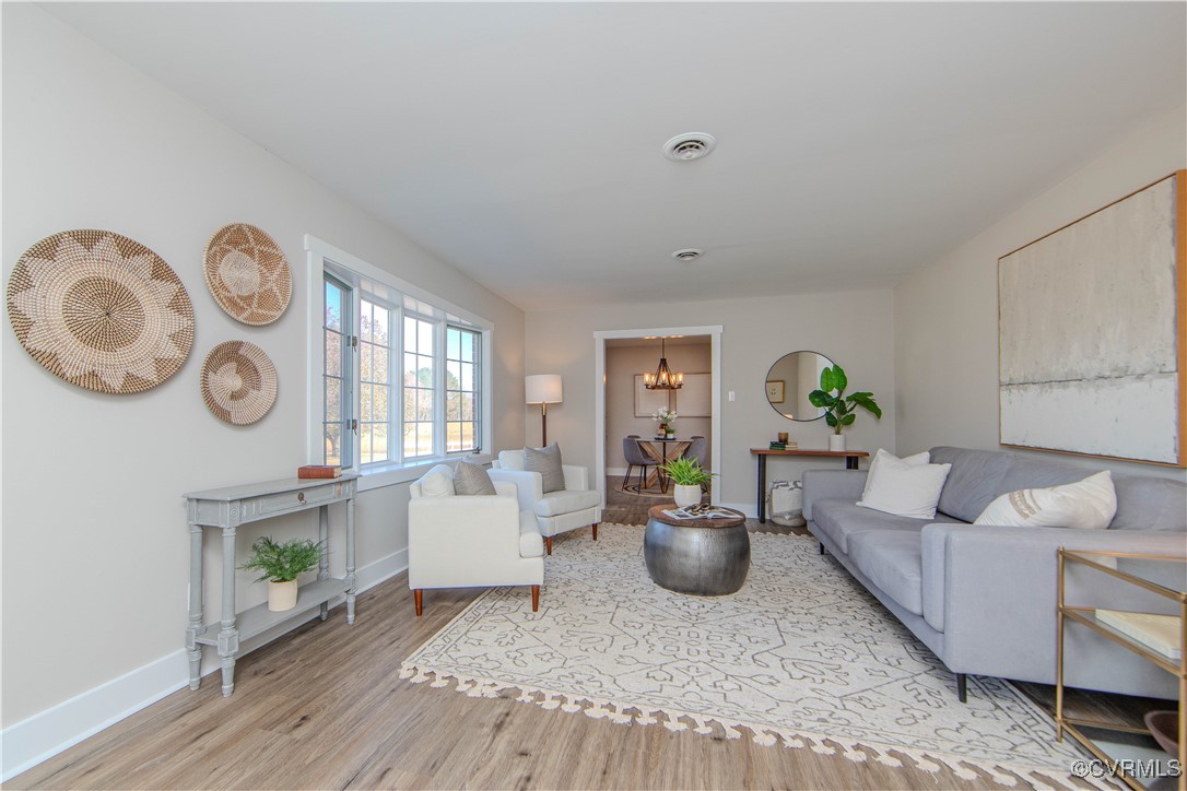 8717 Pole Run Road Disputanta, VA 23842 - Photo 8 of 42 Living room featuring a chandelier and light wood-