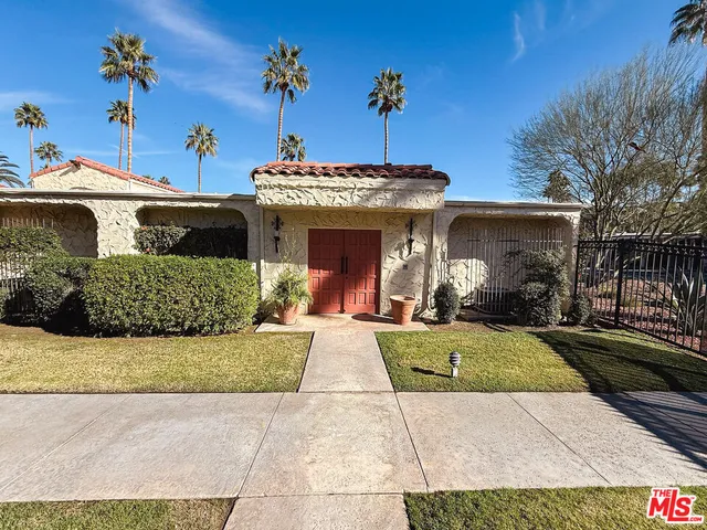 a view of a house with palm trees