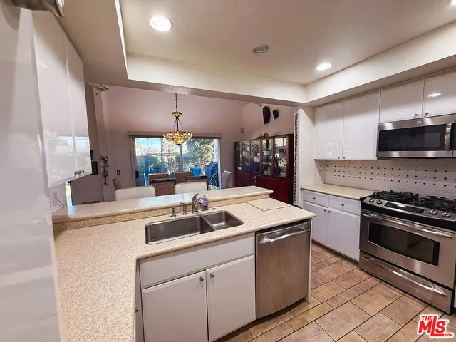 a kitchen with a sink stove and cabinets