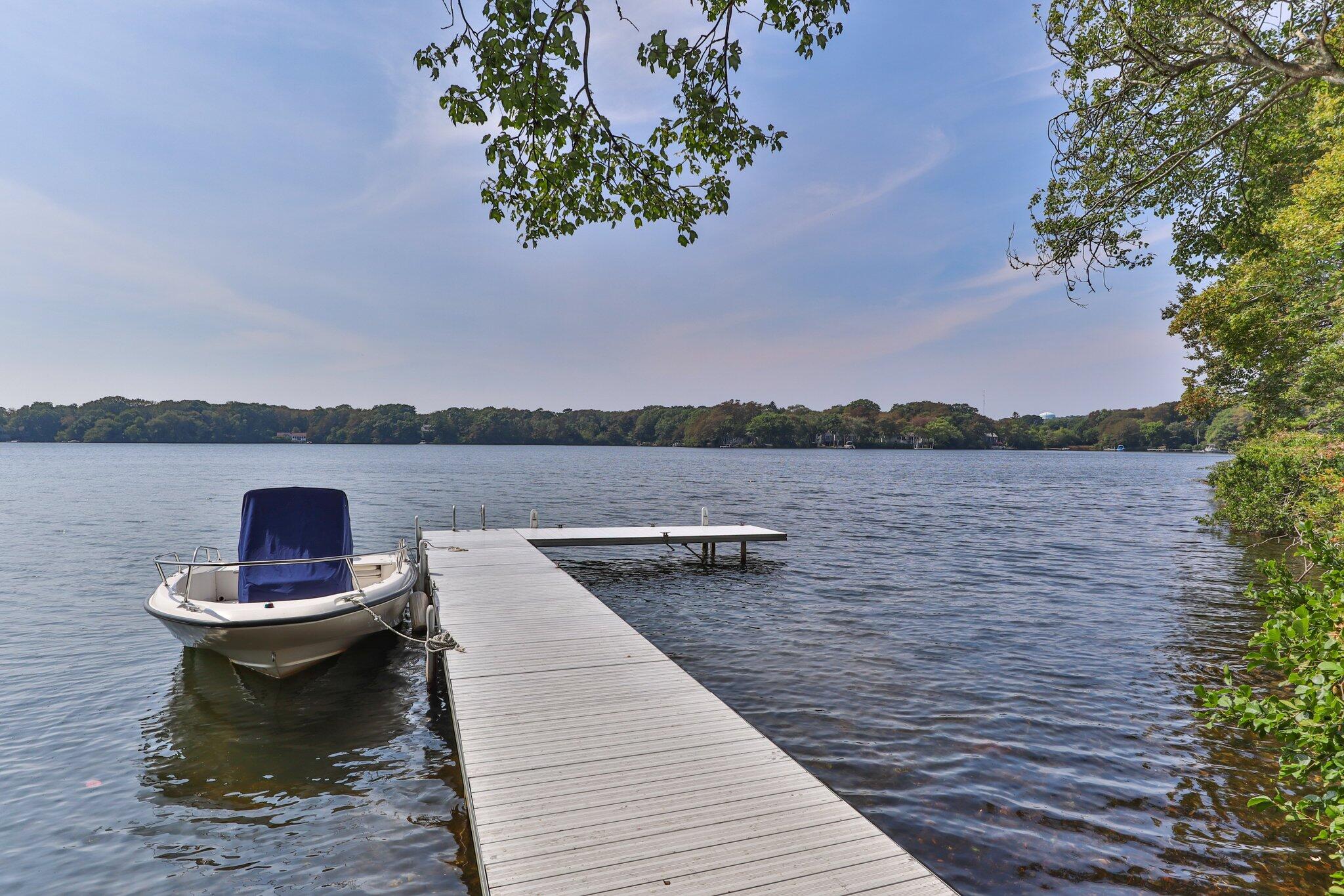 435 Huckins Neck Road Centerville, MA 02632 - Photo 1 of 42 a view of a lake with sitting area