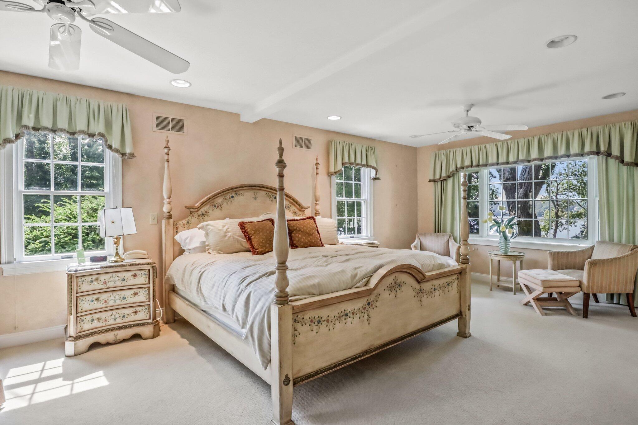 435 Huckins Neck Road Centerville, MA 02632 - Photo 14 of 42 a bed sitting in a spacious bedroom next to a window