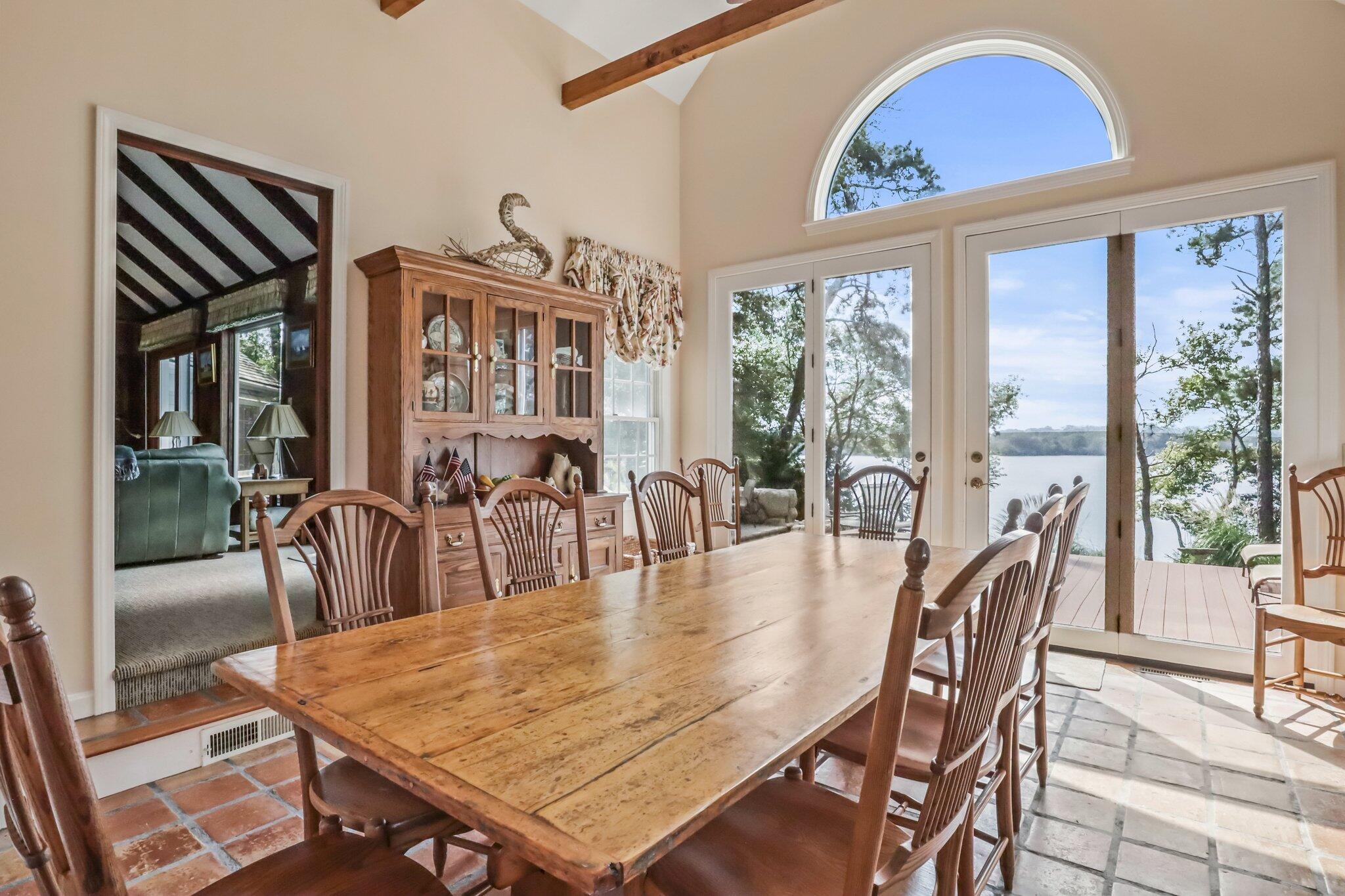 435 Huckins Neck Road Centerville, MA 02632 - Photo 17 of 42 a dining room with furniture a floor to ceiling window and wooden floor