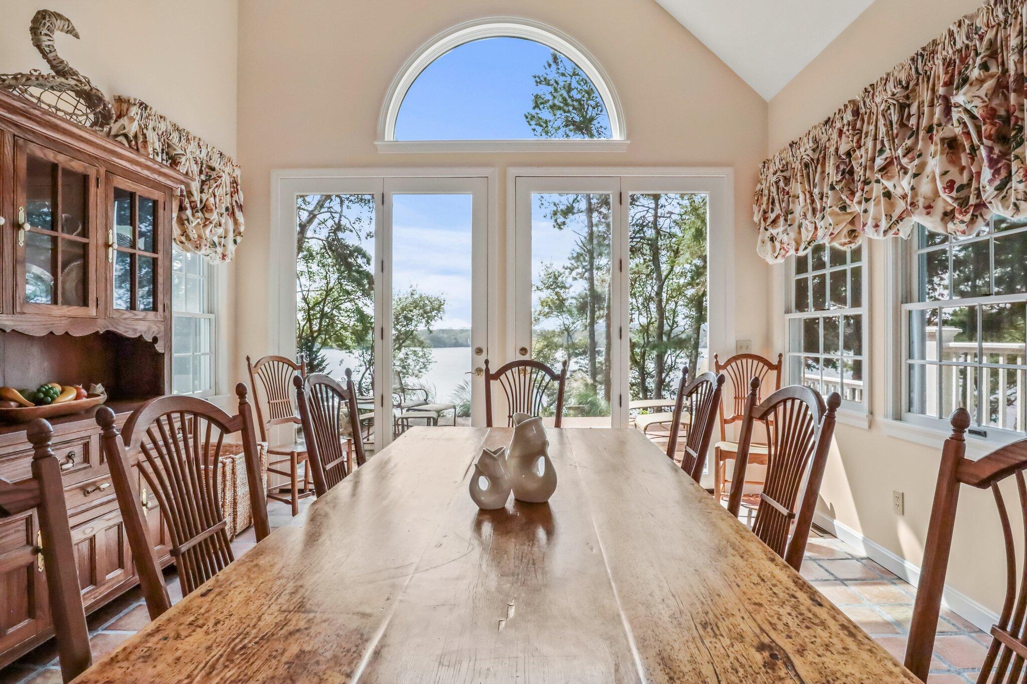 435 Huckins Neck Road Centerville, MA 02632 - Photo 18 of 42 a dining room with furniture a chandelier and wooden floor