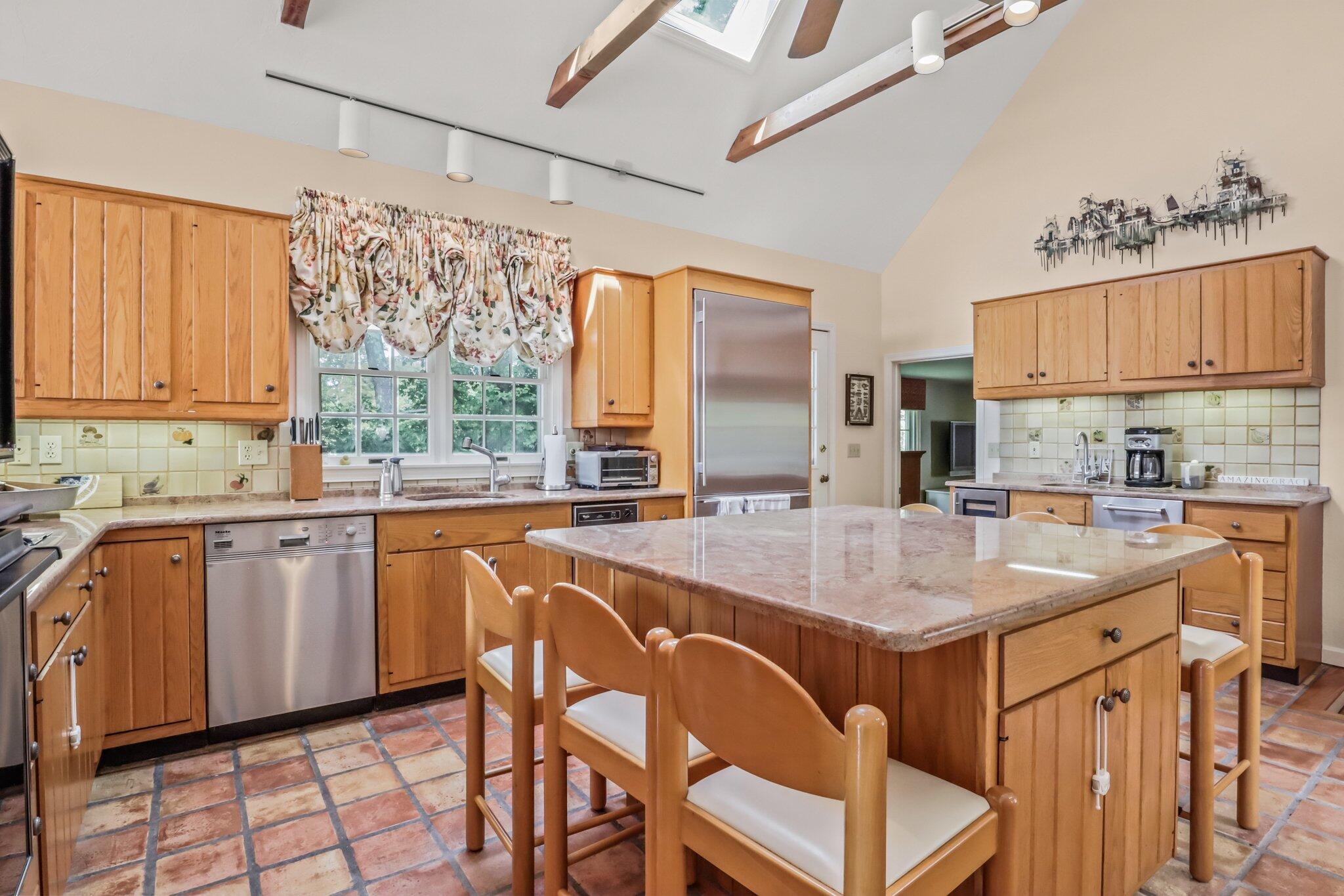 435 Huckins Neck Road Centerville, MA 02632 - Photo 19 of 42 a kitchen with stainless steel appliances granite countertop a sink and cabinets