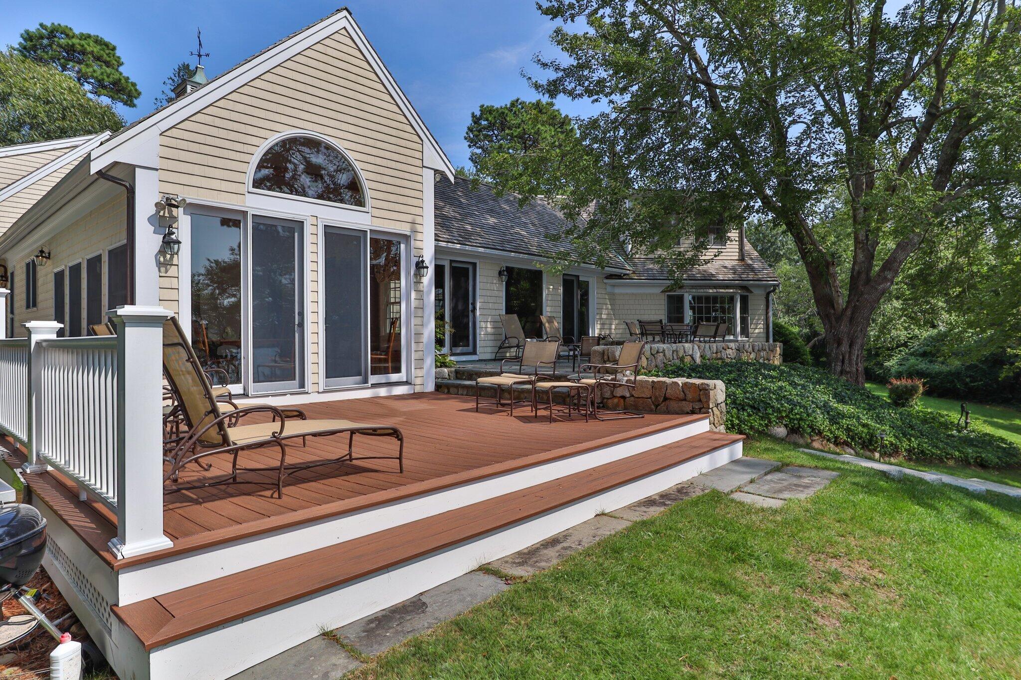 435 Huckins Neck Road Centerville, MA 02632 - Photo 32 of 42 a view of a house with backyard sitting area and garden