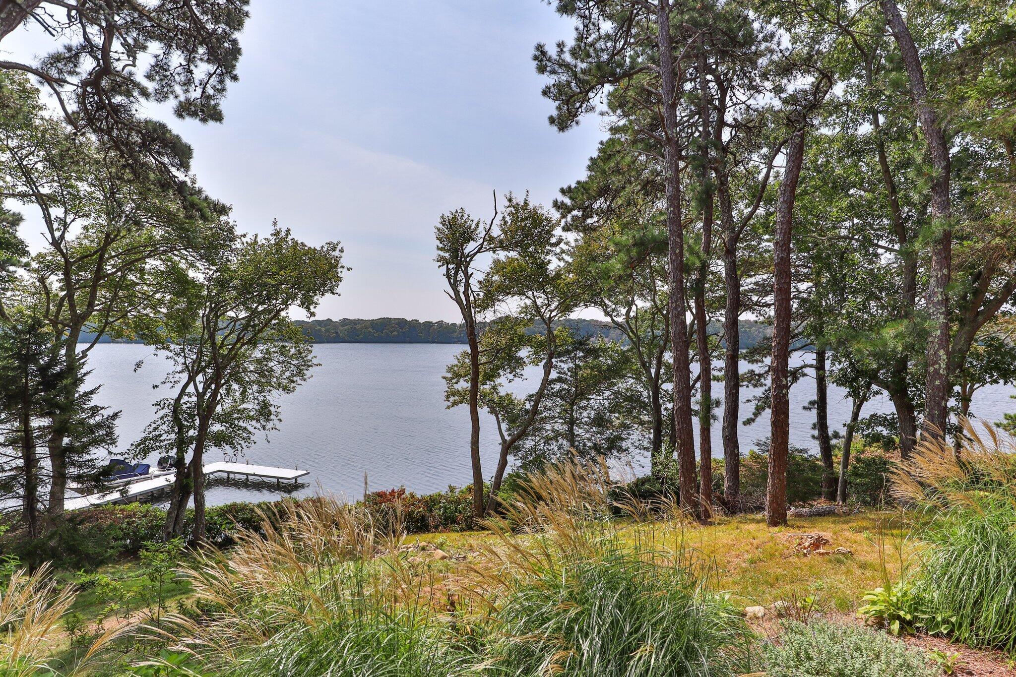 435 Huckins Neck Road Centerville, MA 02632 - Photo 36 of 42 a backyard of a house with lots of green space
