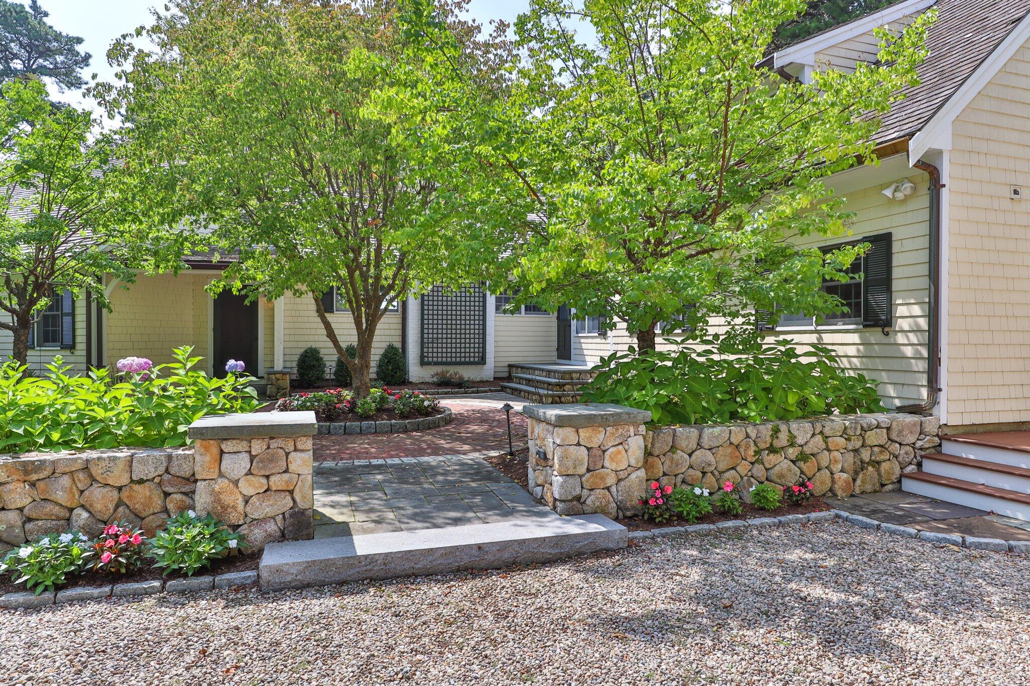 435 Huckins Neck Road Centerville, MA 02632 - Photo 6 of 42 a front view of a house with garden