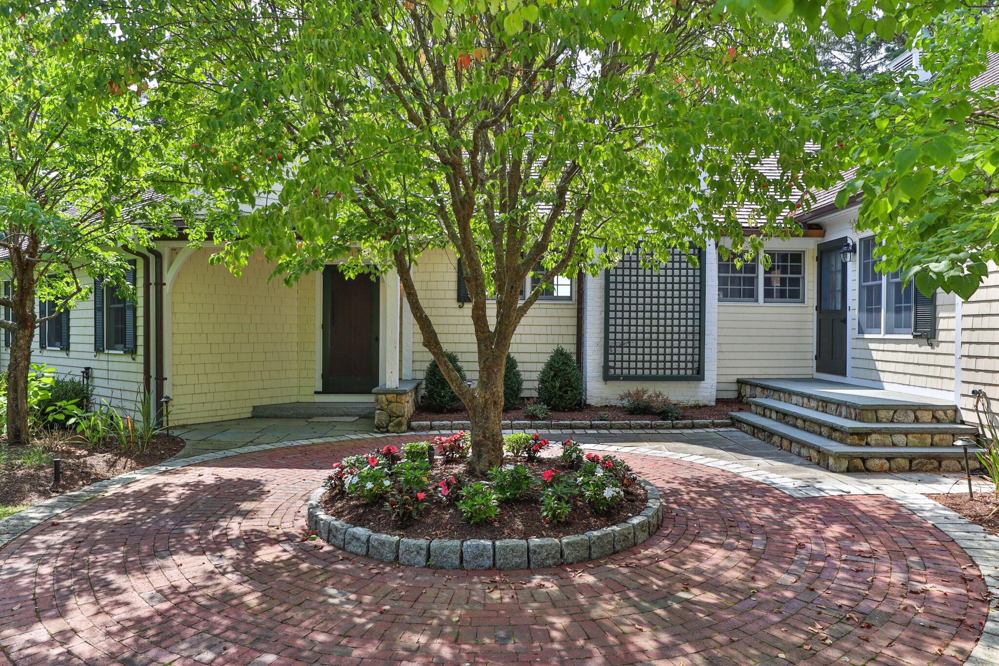 435 Huckins Neck Road Centerville, MA 02632 - Photo 7 of 42 a front view of a house with a garden