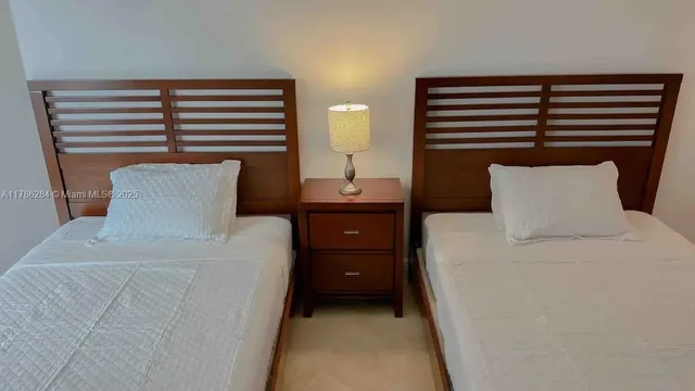 a bedroom with a bed and a night stand