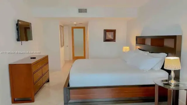 a bed room with a bed window and television