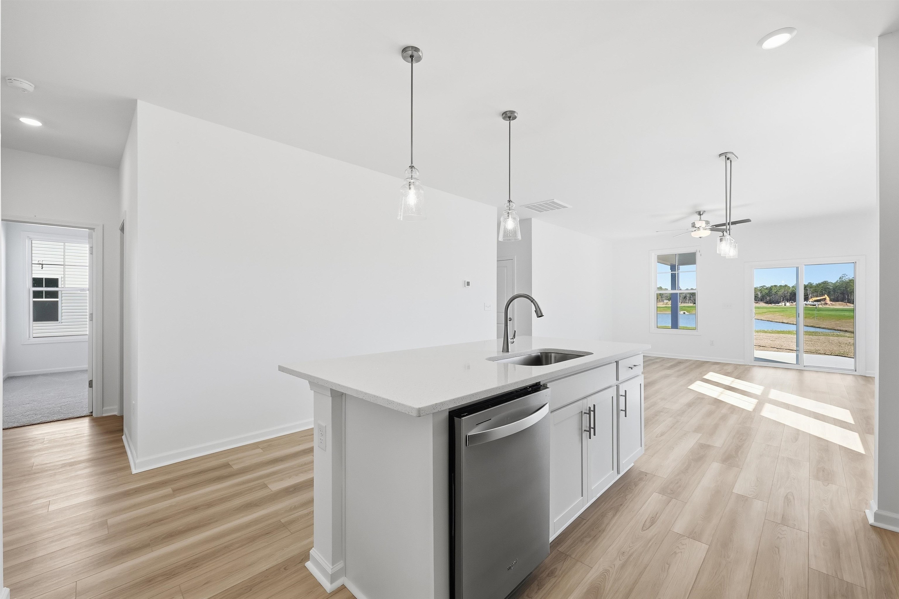 142 River Birch Drive Loris, SC 29569 - Photo 12 of 39 Kitchen with recessed lighting, dishwasher, decorative light fixtures, white cabinetry, and a kitchen island with sink