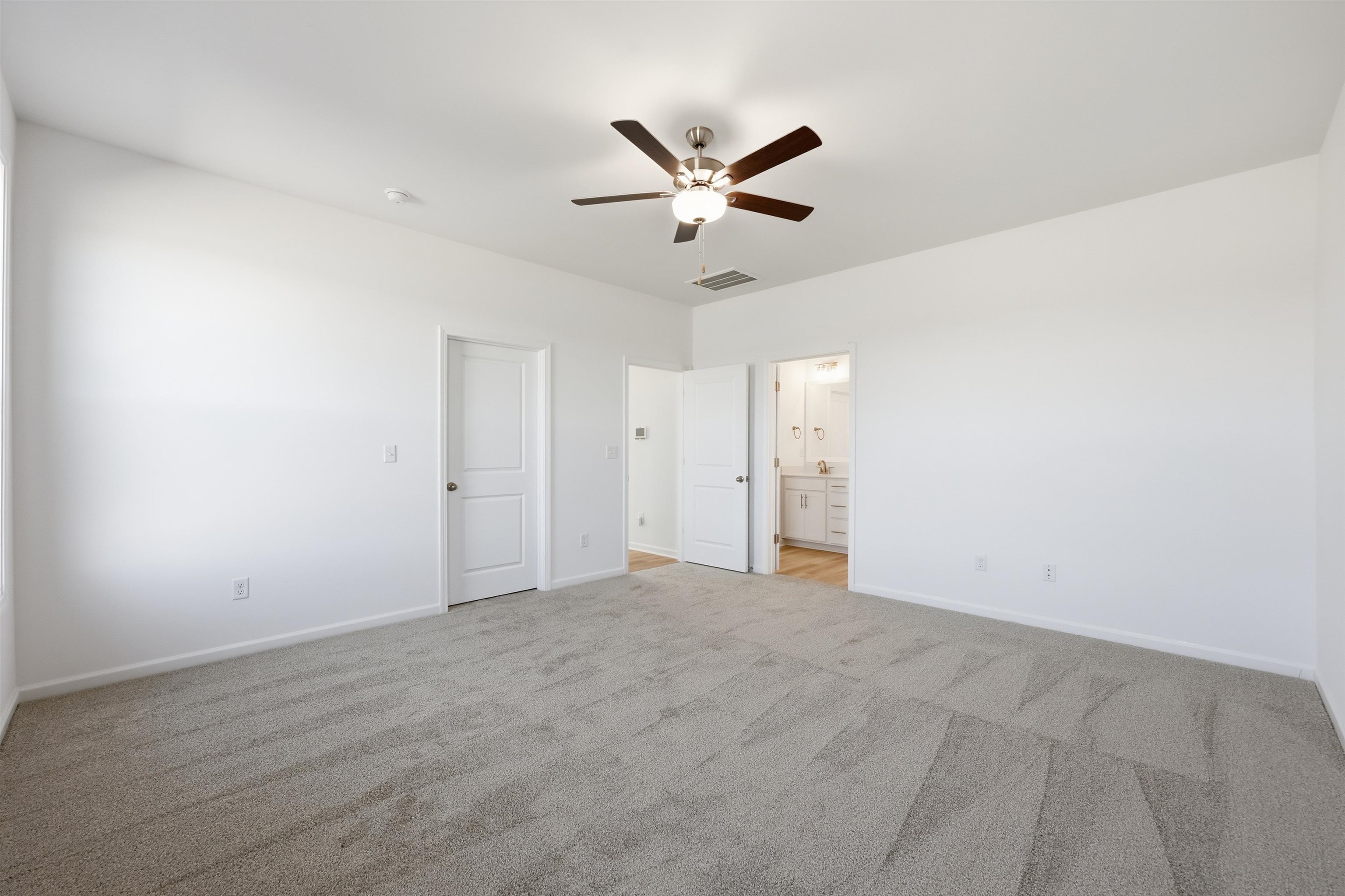 142 River Birch Drive Loris, SC 29569 - Photo 15 of 39 Unfurnished bedroom with ceiling fan, light carpet, and ensuite bath