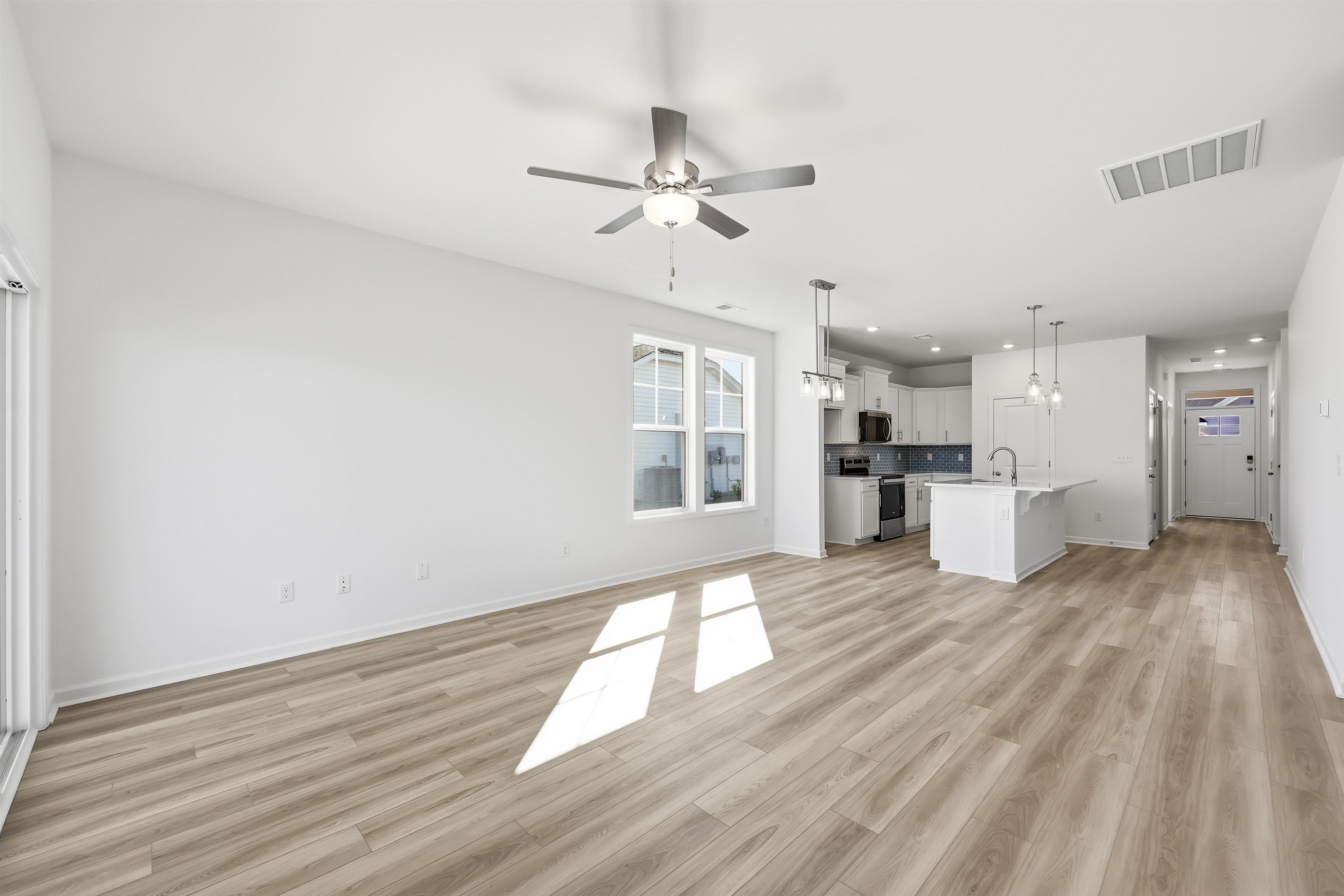 142 River Birch Drive Loris, SC 29569 - Photo 5 of 39 Unfurnished living room with a ceiling fan, light wood finished floors, and recessed lighting