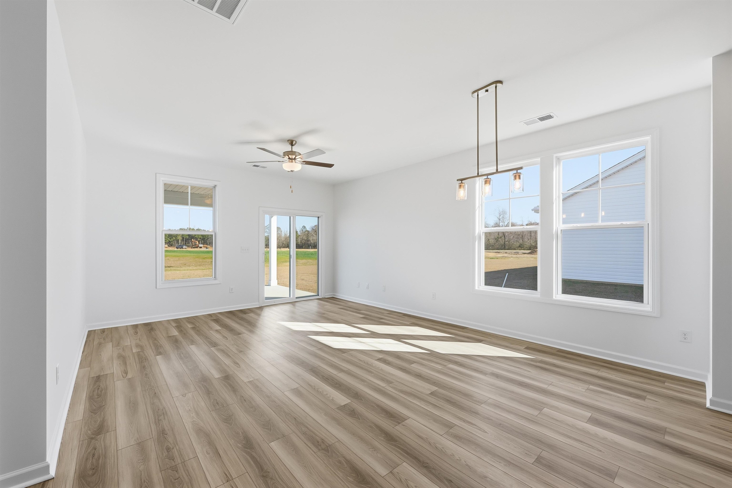 142 River Birch Drive Loris, SC 29569 - Photo 7 of 39 Empty room with light wood-type flooring and a ceiling fan