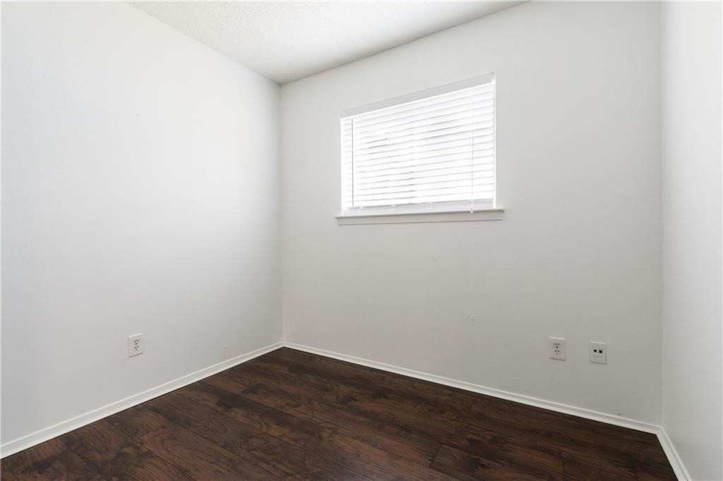 6005 Hogan Avenue Austin, TX 78741 - Photo 13 of 19 an empty room with wooden floor and windows