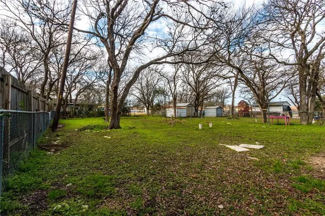 a backyard of a house with lots of green space and trees